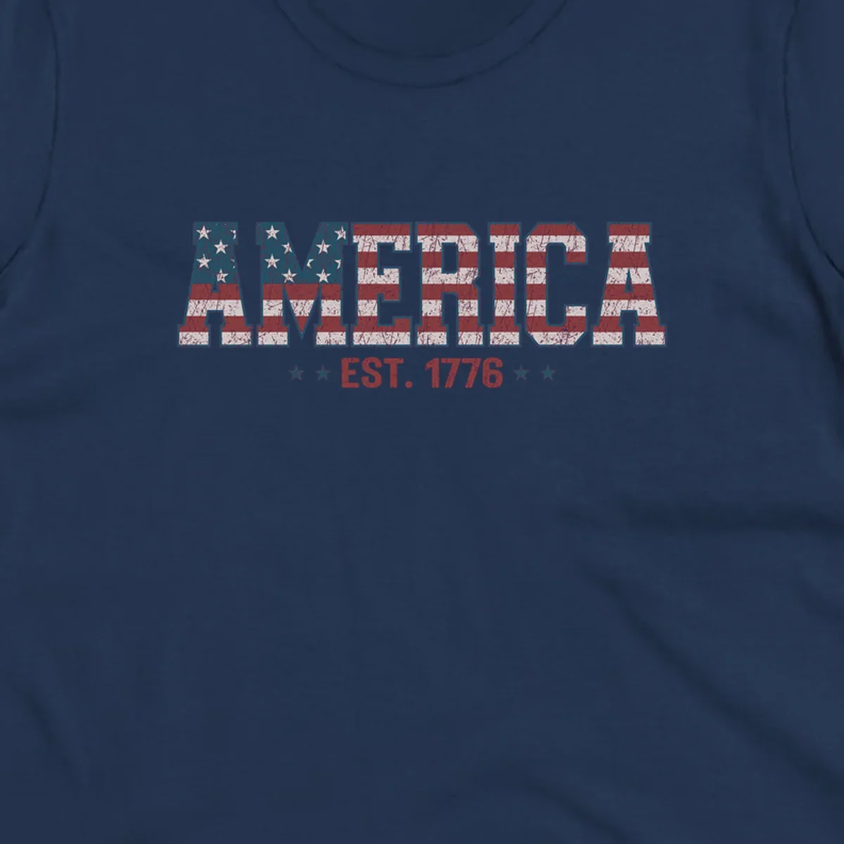 Distressed America Est. 1776 flag design with red, white, and blue flag pattern on block letters and stars.