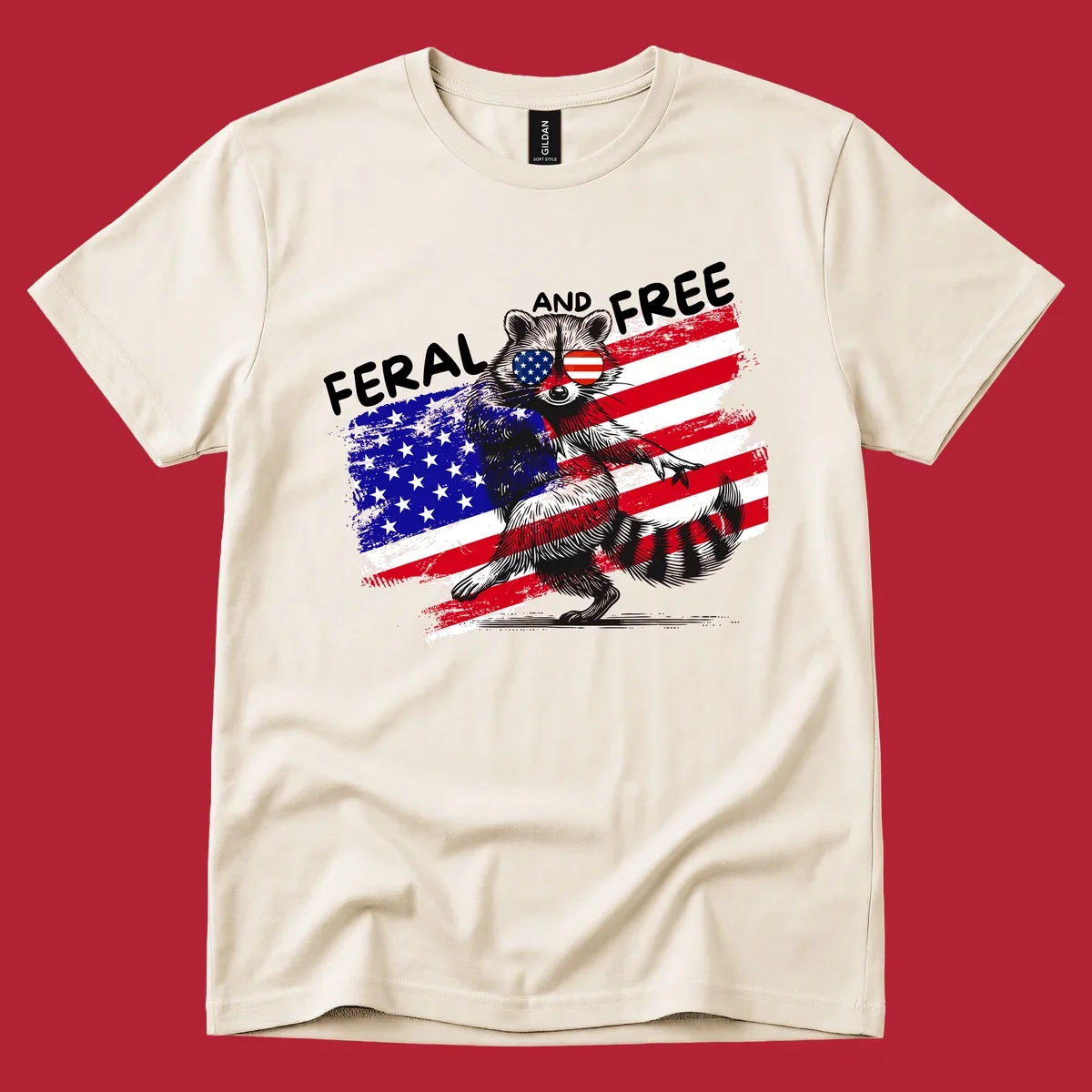 A standing raccoon with an American flag design and USA flag sunglasses, with the text 'FERAL AND FREE'. feral-free-raccoon-flag.