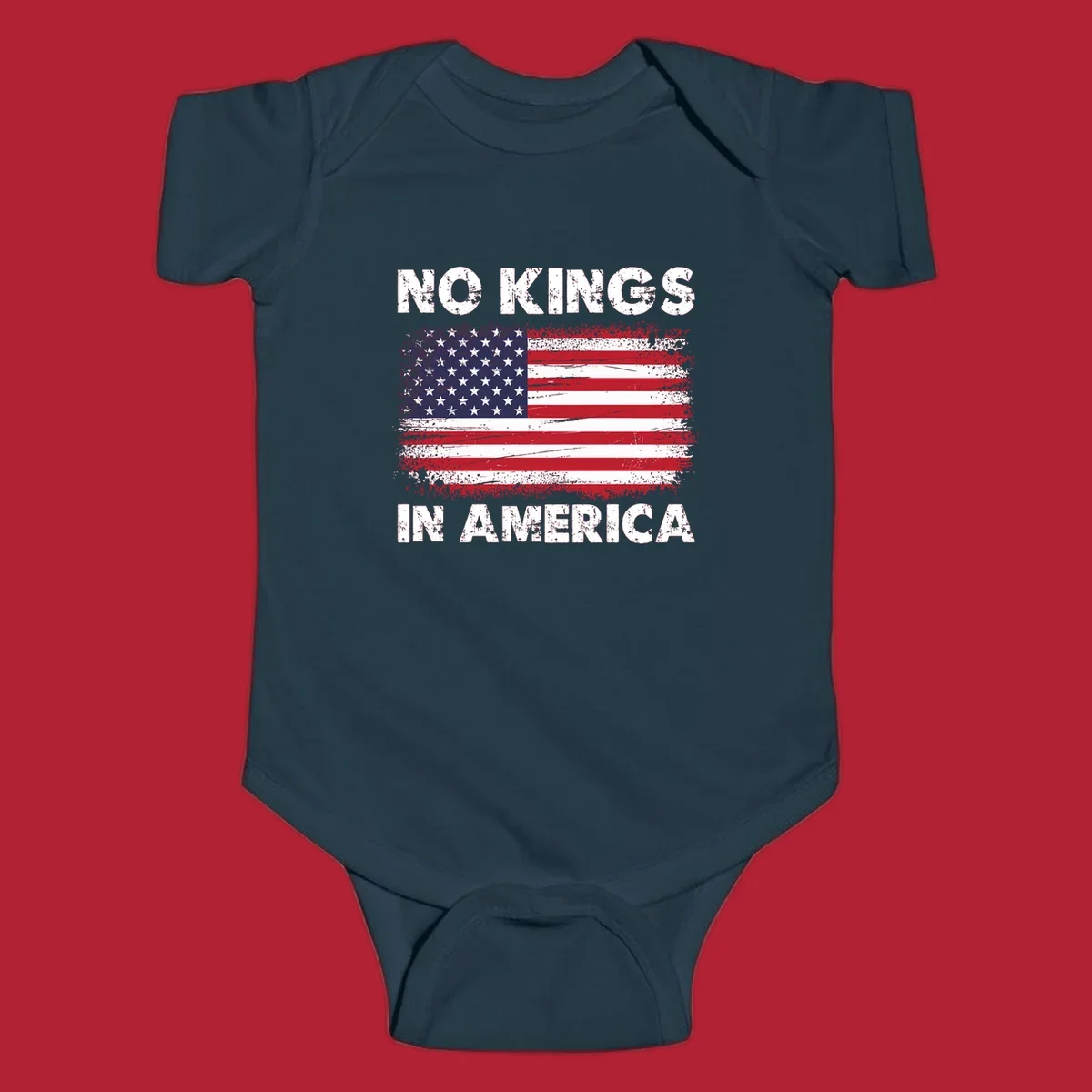 A distressed American flag with the white text 'NO KINGS IN AMERICA' above and below it.