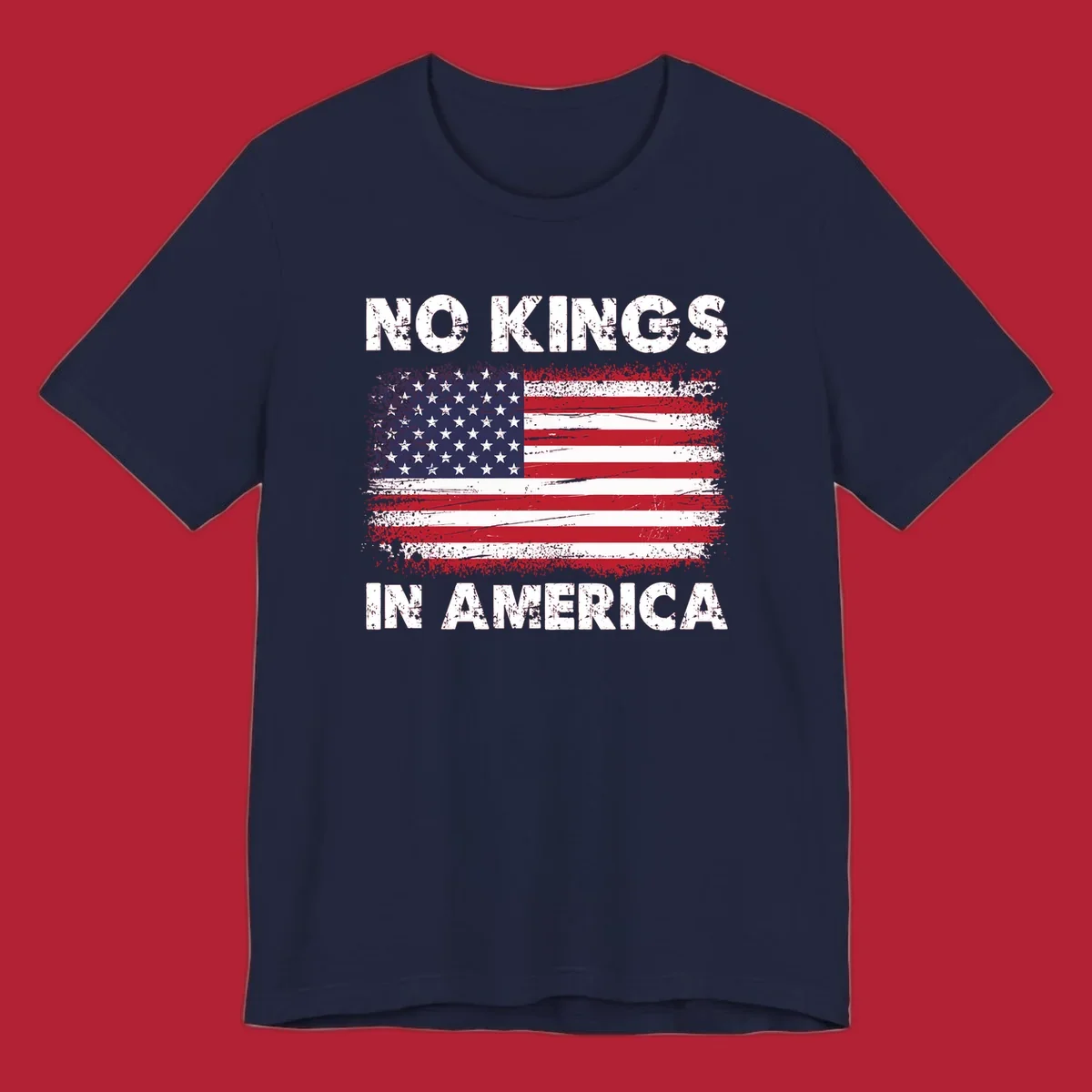 A distressed American flag with the white text 'NO KINGS IN AMERICA' above and below it.