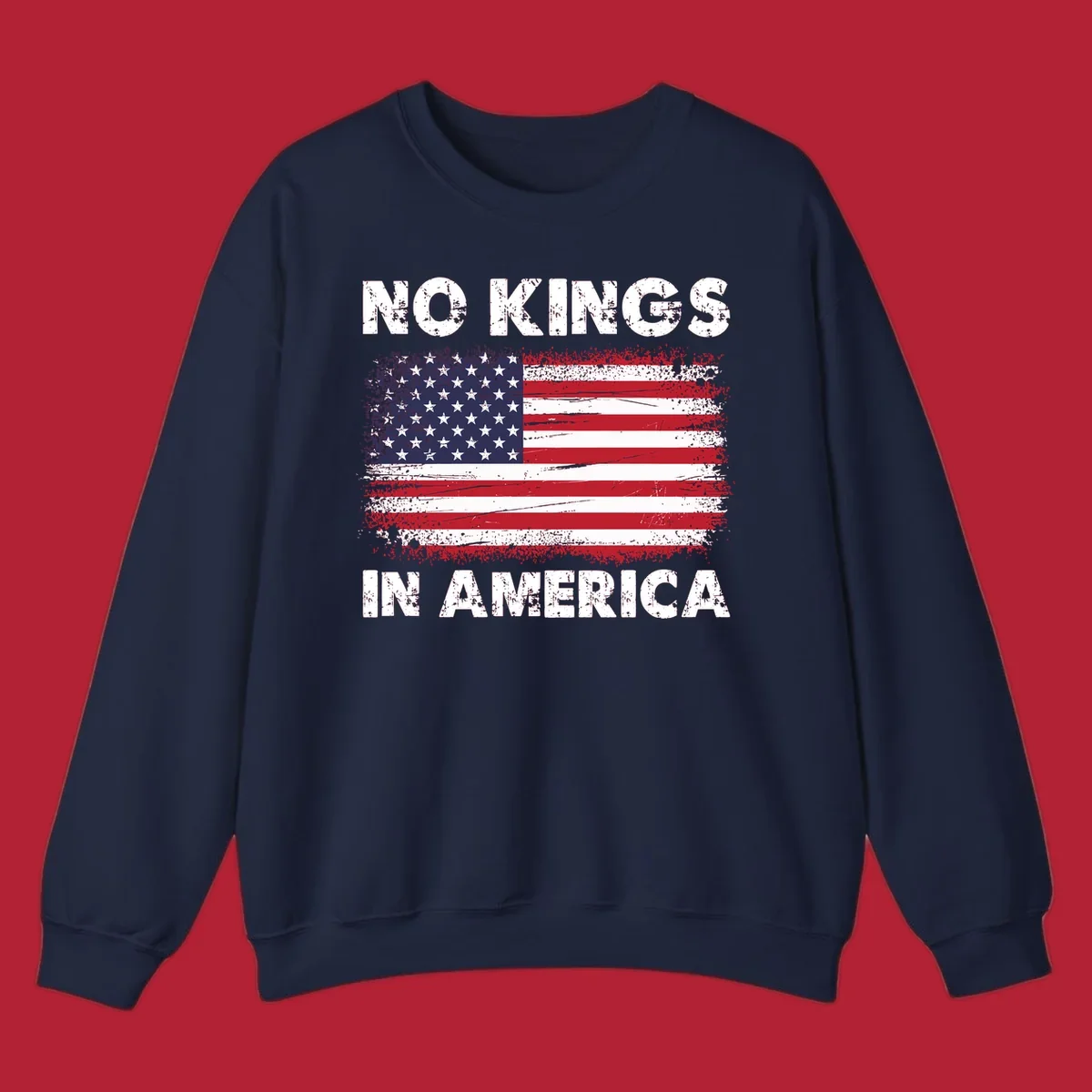 A distressed American flag with the white text 'NO KINGS IN AMERICA' above and below it.