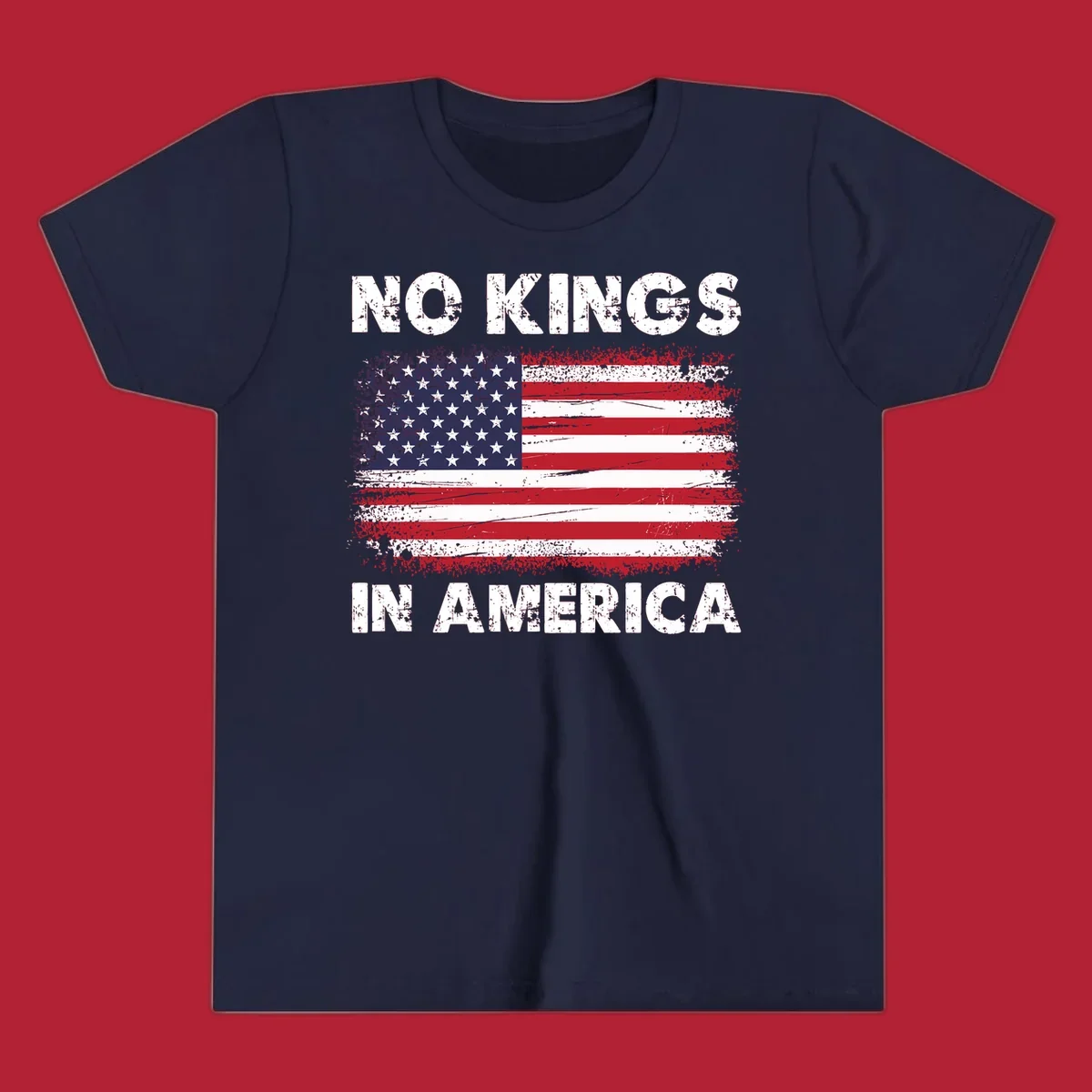 A distressed American flag with the white text 'NO KINGS IN AMERICA' above and below it.