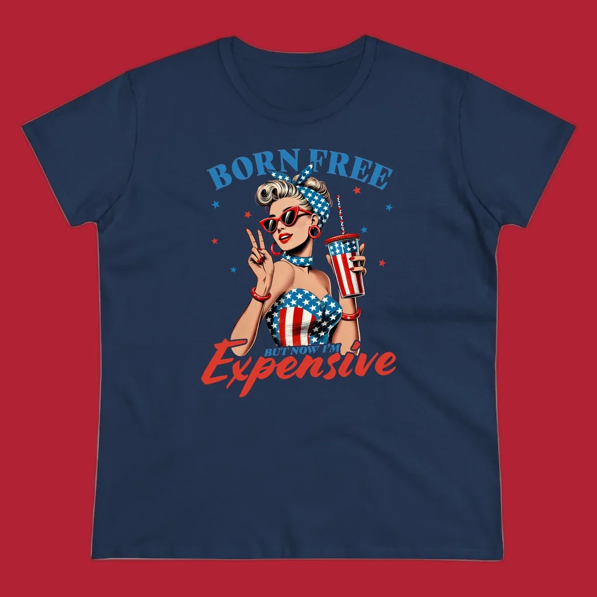 A vintage pin-up girl with a patriotic outfit and cup, making a peace sign, with the text "Born Free But Now I'm Expensive". This born-free-expensive-pinup design is surrounded by stars.