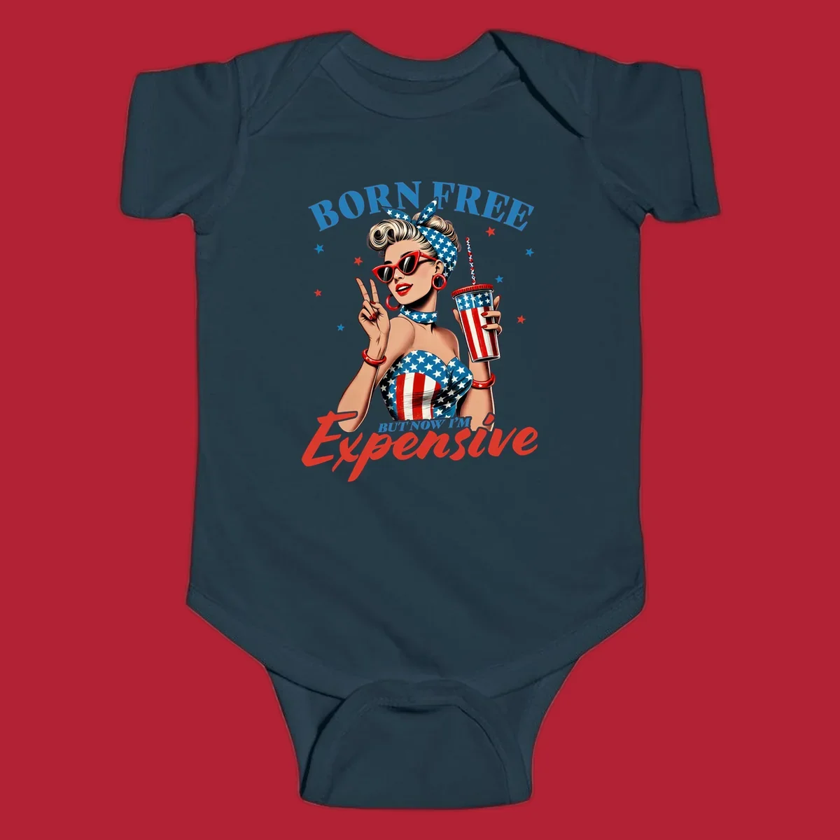 A vintage pin-up girl with a patriotic outfit and cup, making a peace sign, with the text "Born Free But Now I'm Expensive". This born-free-expensive-pinup design is surrounded by stars.