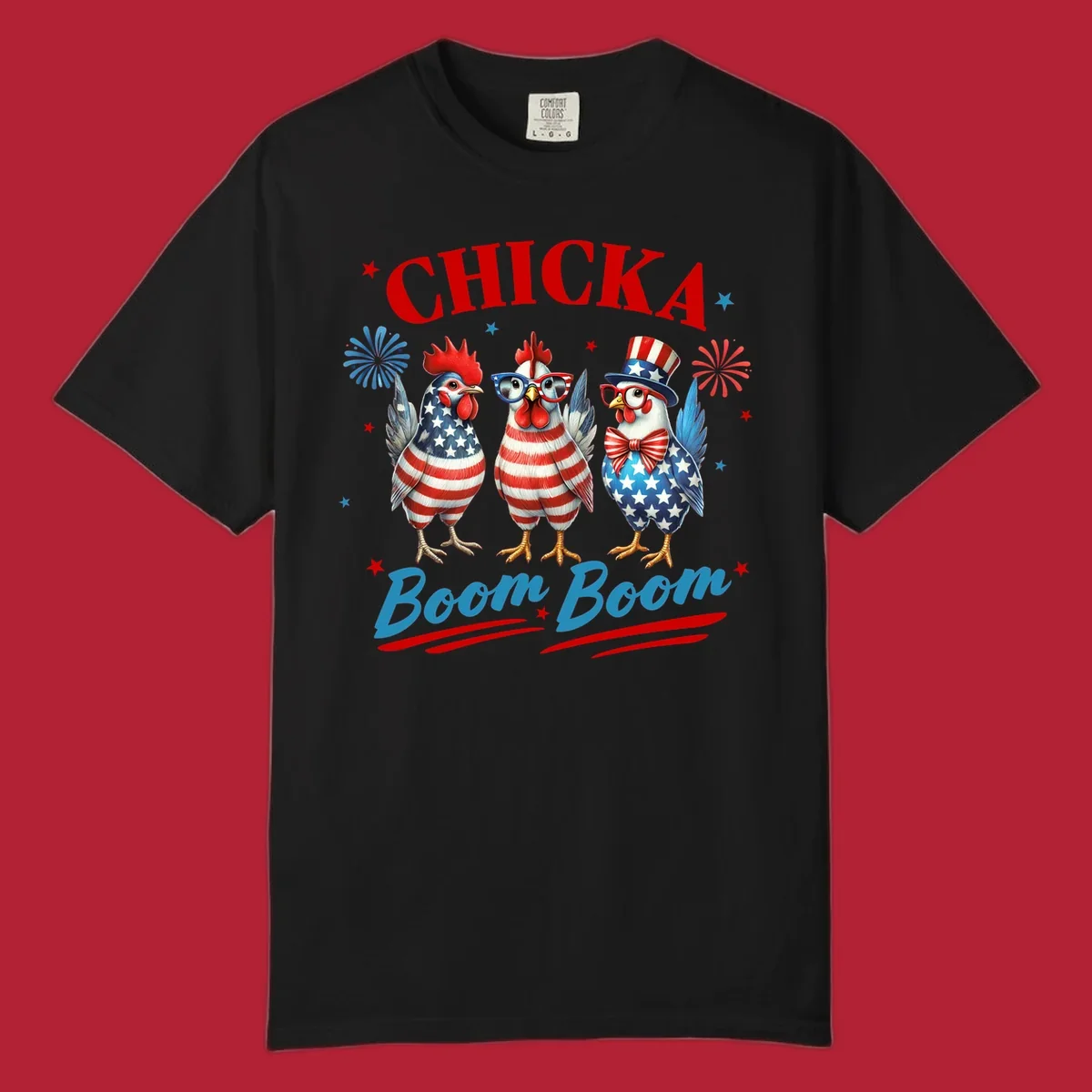 Three patriotic chickens in American flag patterns with fireworks and stars, text reads 'Chicka Boom Boom'. Features the chicka-boom-boom-patriotic-chickens concept.