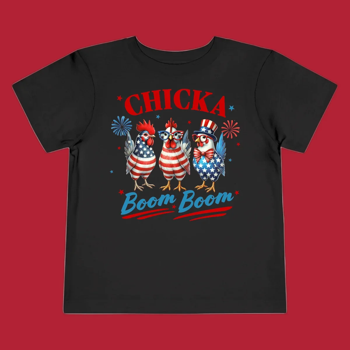 Three patriotic chickens in American flag patterns with fireworks and stars, text reads 'Chicka Boom Boom'. Features the chicka-boom-boom-patriotic-chickens concept.