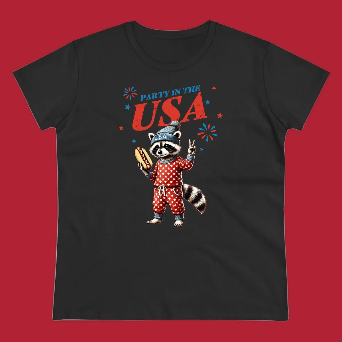 A cartoon raccoon wearing a USA beanie and star-patterned pajamas, holding a hotdog and making a peace sign, with 'PARTY IN THE USA' text and fireworks.