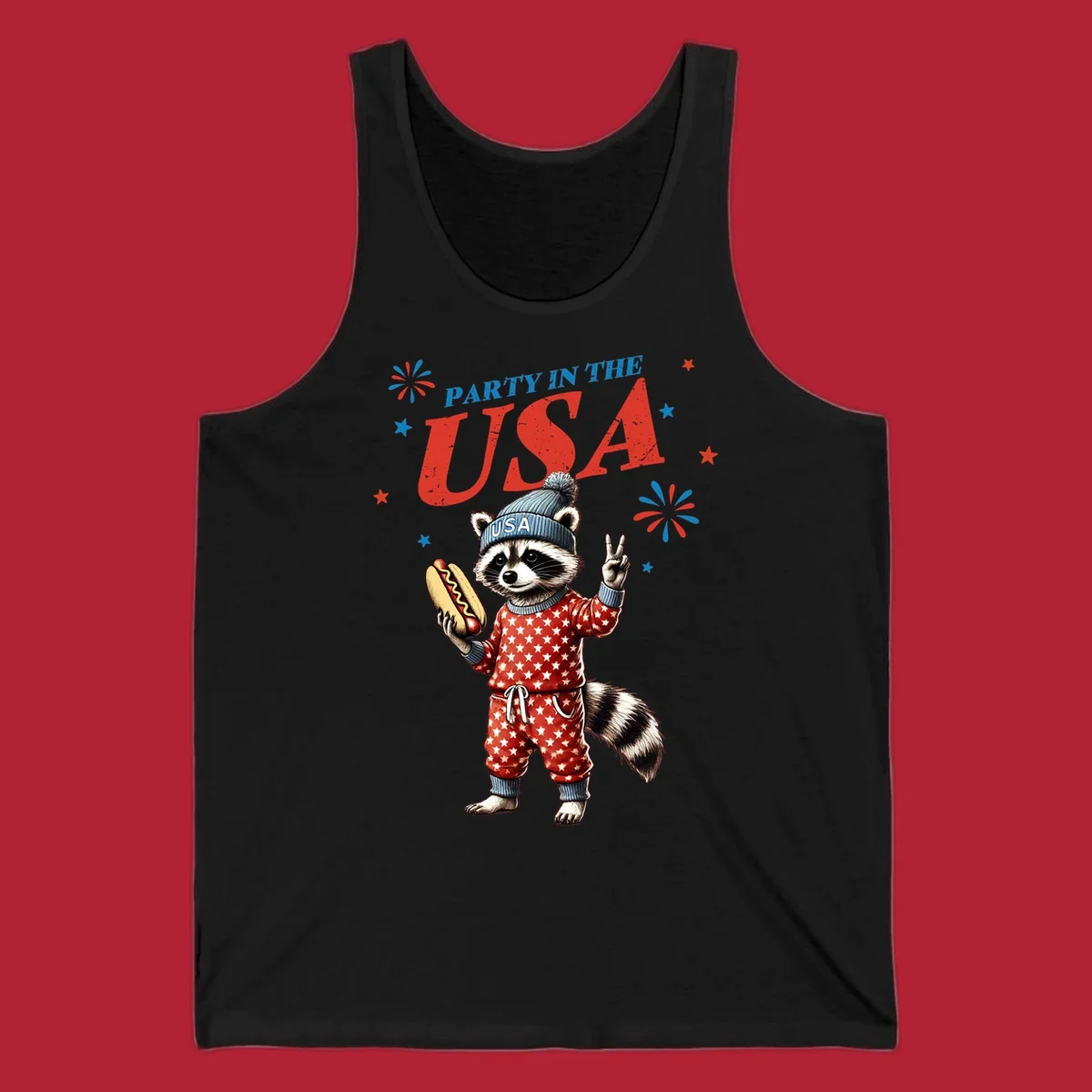 A cartoon raccoon wearing a USA beanie and star-patterned pajamas, holding a hotdog and making a peace sign, with 'PARTY IN THE USA' text and fireworks.