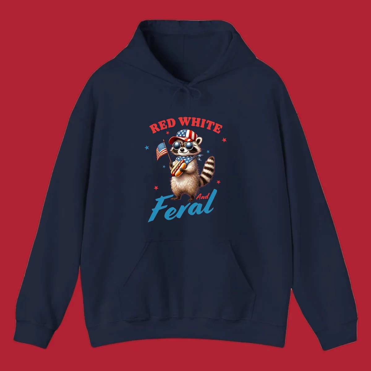A cartoon raccoon wearing a patriotic hat and bandana, holding an American flag and a hot dog, with 'Red White And Feral' text. This is a red-white-feral-raccoon design.