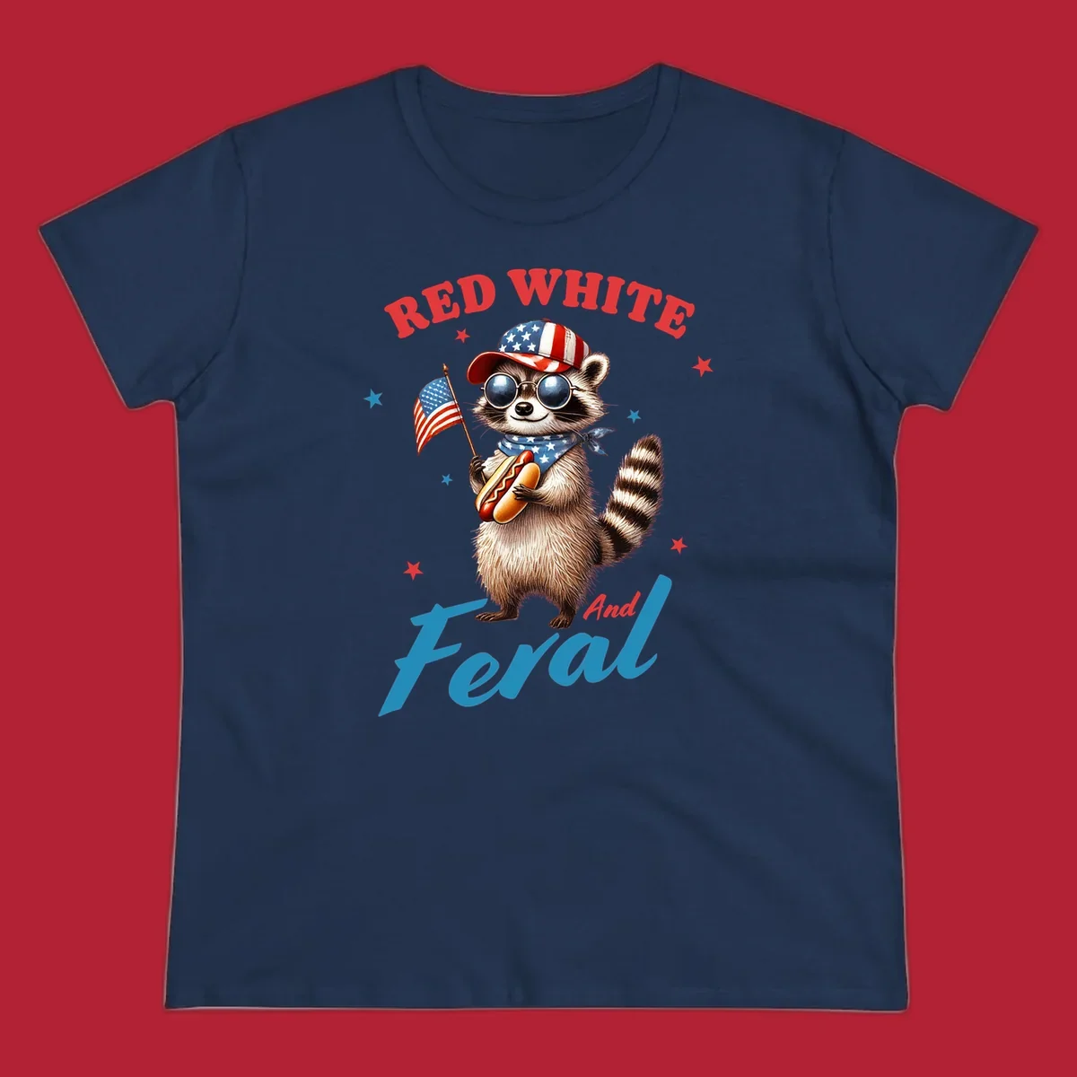 A cartoon raccoon wearing a patriotic hat and bandana, holding an American flag and a hot dog, with 'Red White And Feral' text. This is a red-white-feral-raccoon design.