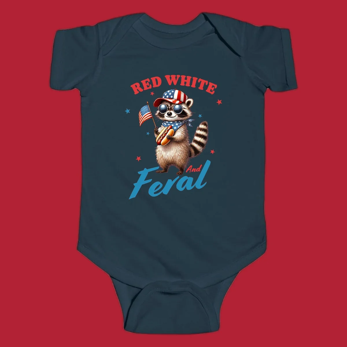 A cartoon raccoon wearing a patriotic hat and bandana, holding an American flag and a hot dog, with 'Red White And Feral' text. This is a red-white-feral-raccoon design.