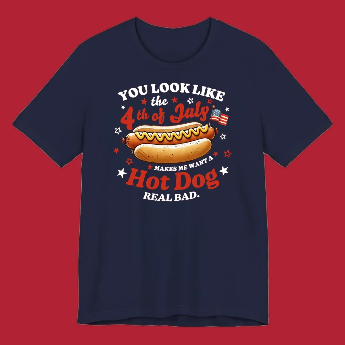 An illustrated hot dog with mustard, American flags, and stars. Text reads "YOU LOOK LIKE the 4th of July MAKES ME WANT A Hot Dog REAL BAD." you-look-like-4th-july design.