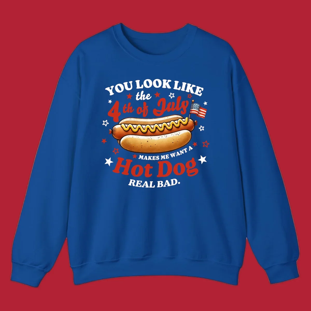 An illustrated hot dog with mustard, American flags, and stars. Text reads "YOU LOOK LIKE the 4th of July MAKES ME WANT A Hot Dog REAL BAD." you-look-like-4th-july design.