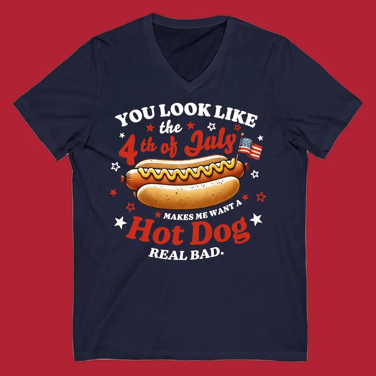 An illustrated hot dog with mustard, American flags, and stars. Text reads "YOU LOOK LIKE the 4th of July MAKES ME WANT A Hot Dog REAL BAD." you-look-like-4th-july design.
