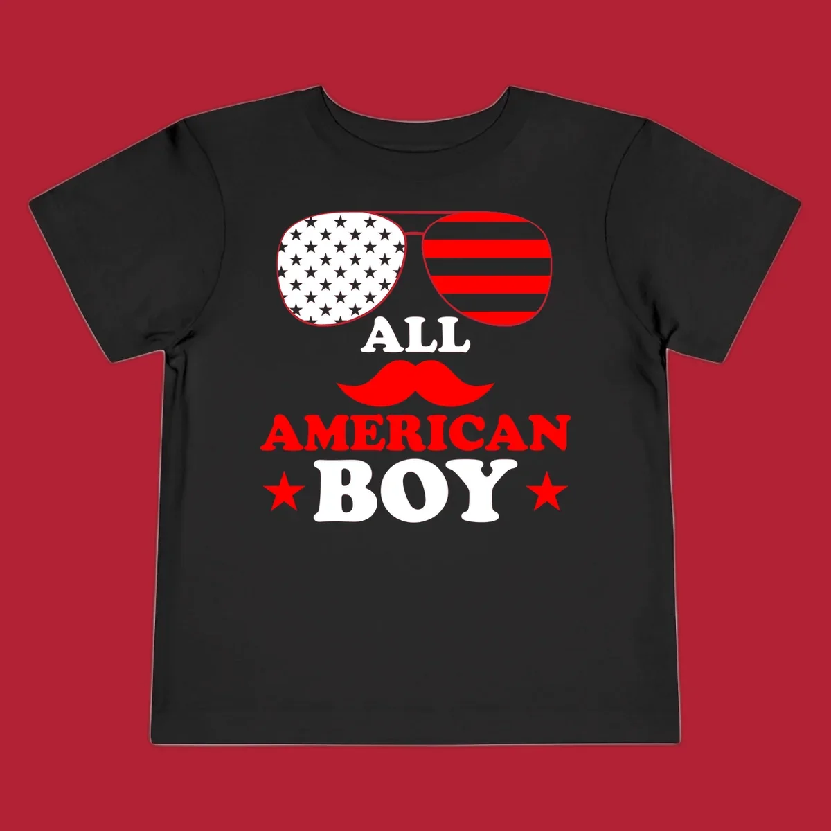 All American Boy patriotic design with aviator sunglasses featuring stars and stripes, a red mustache, and bold text.