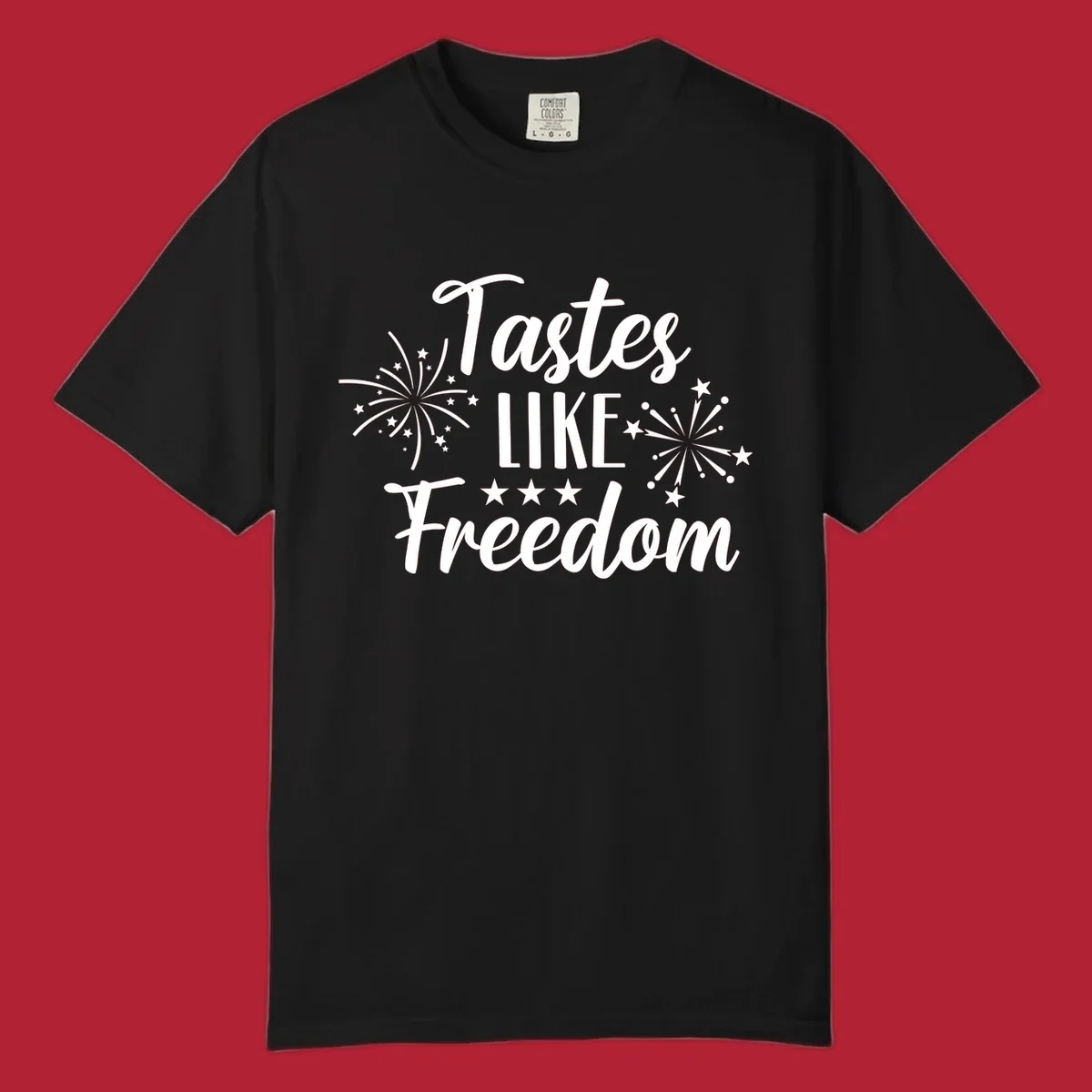 A patriotic design with the phrase 'Tastes LIKE Freedom' in script and block letters, surrounded by fireworks and stars.