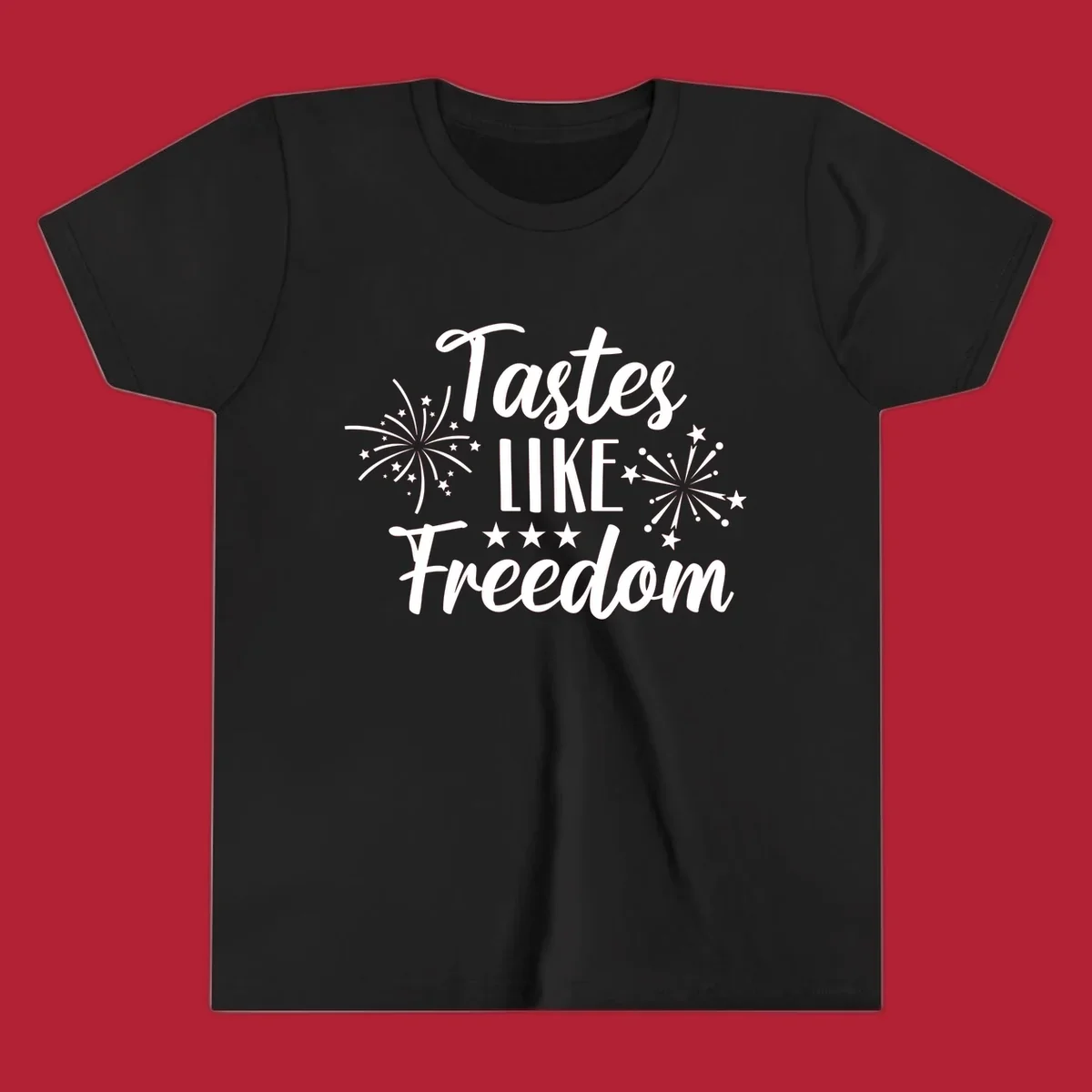 A patriotic design with the phrase 'Tastes LIKE Freedom' in script and block letters, surrounded by fireworks and stars.