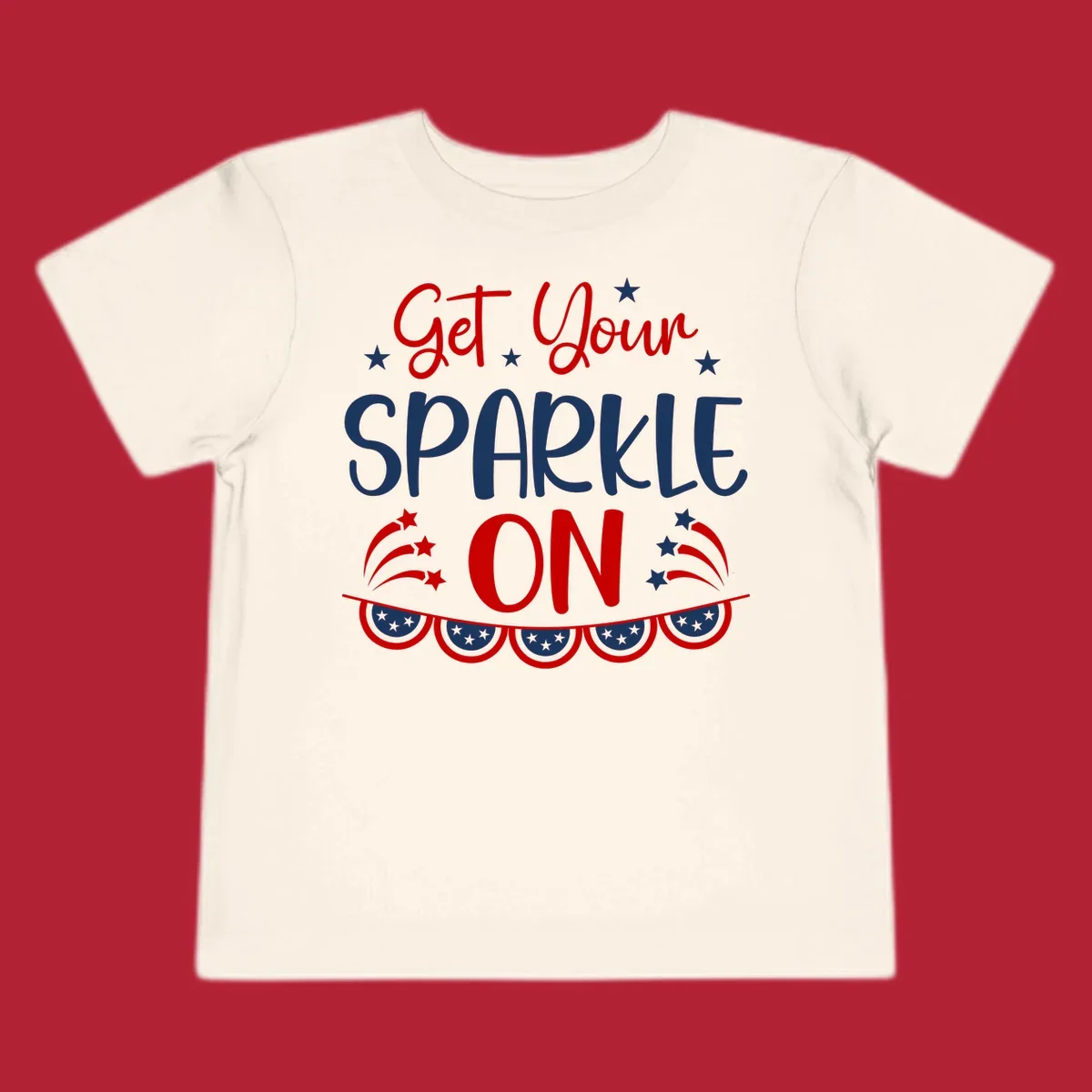 A patriotic design with the phrase 'Get Your SPARKLE ON' in red and blue, surrounded by white stars, fireworks, and bunting flags.