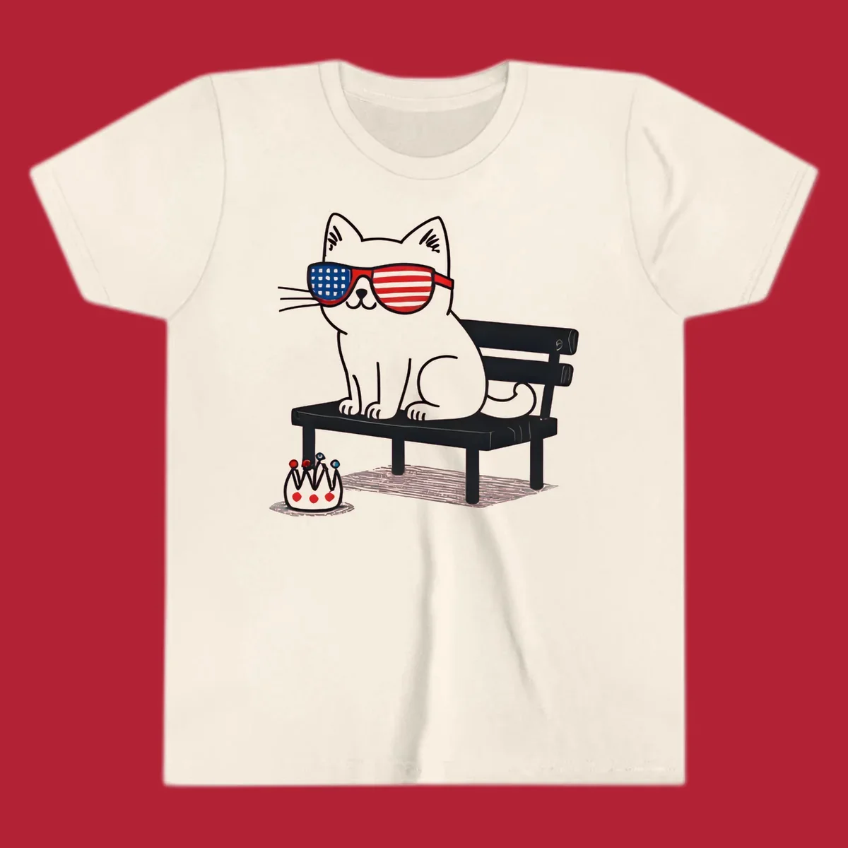 A black cat with American flag sunglasses sits on a bench, next to a small patriotic crown. Features a patriotic-cat-sunglasses concept.
