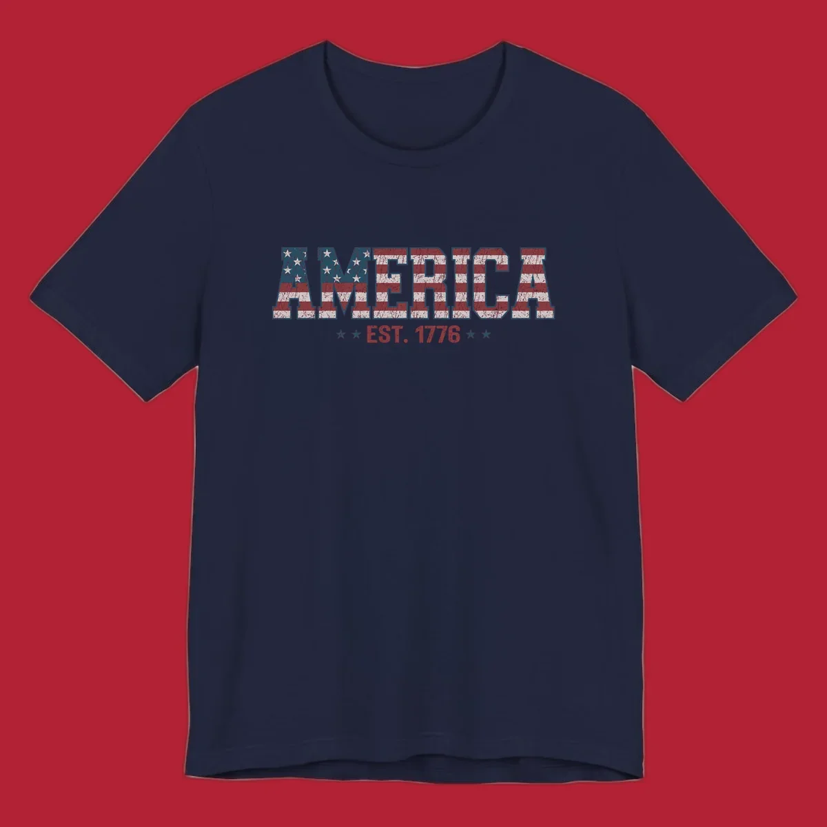 Distressed America Est. 1776 flag design with red, white, and blue flag pattern on block letters and stars.
