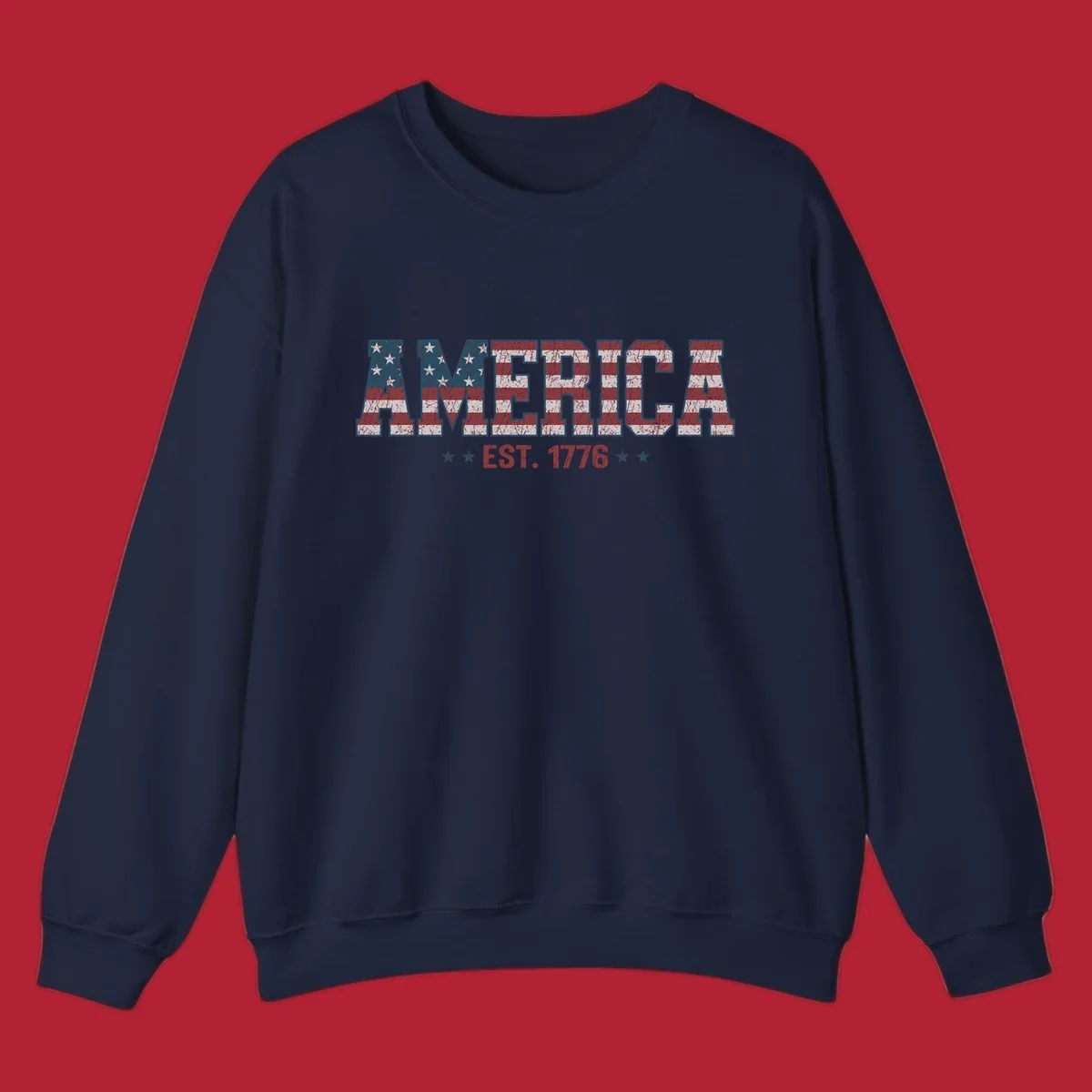 Distressed America Est. 1776 flag design with red, white, and blue flag pattern on block letters and stars.