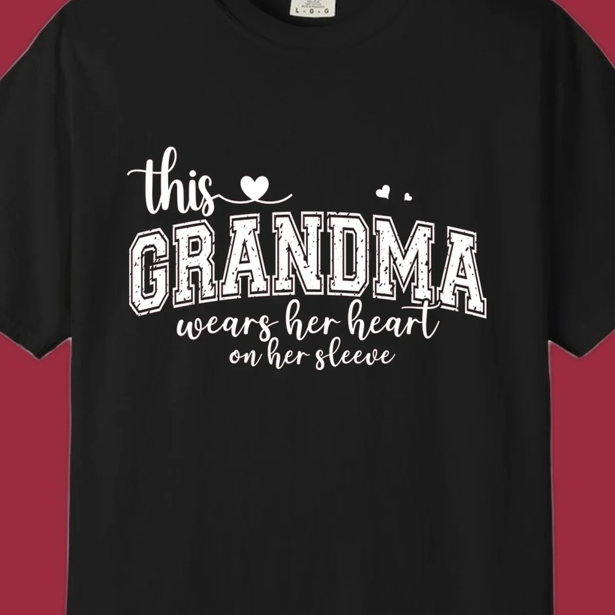 This Grandma Wears Her Heart On Her Sleeve text design with hearts.