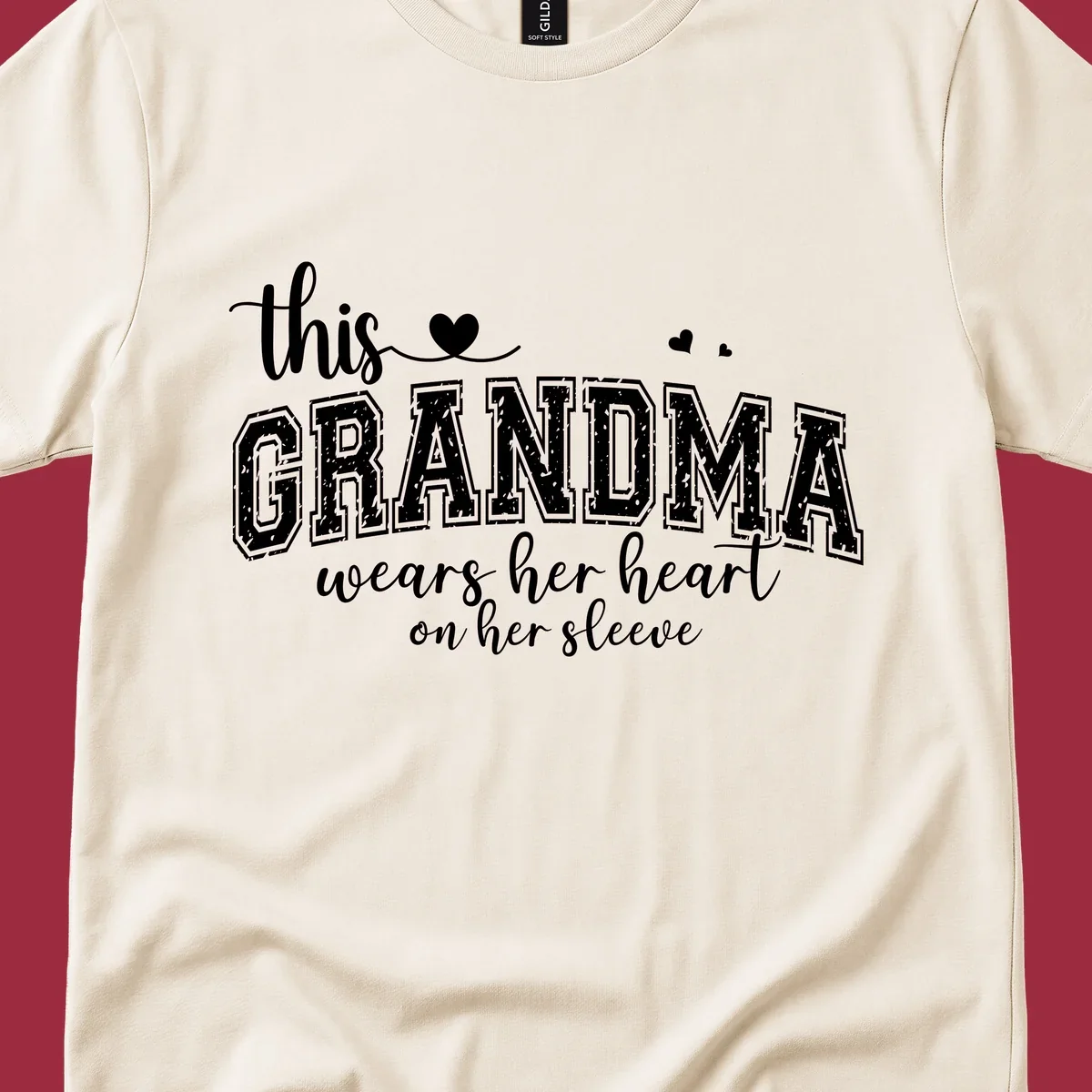 This Grandma Wears Her Heart On Her Sleeve text design with hearts.