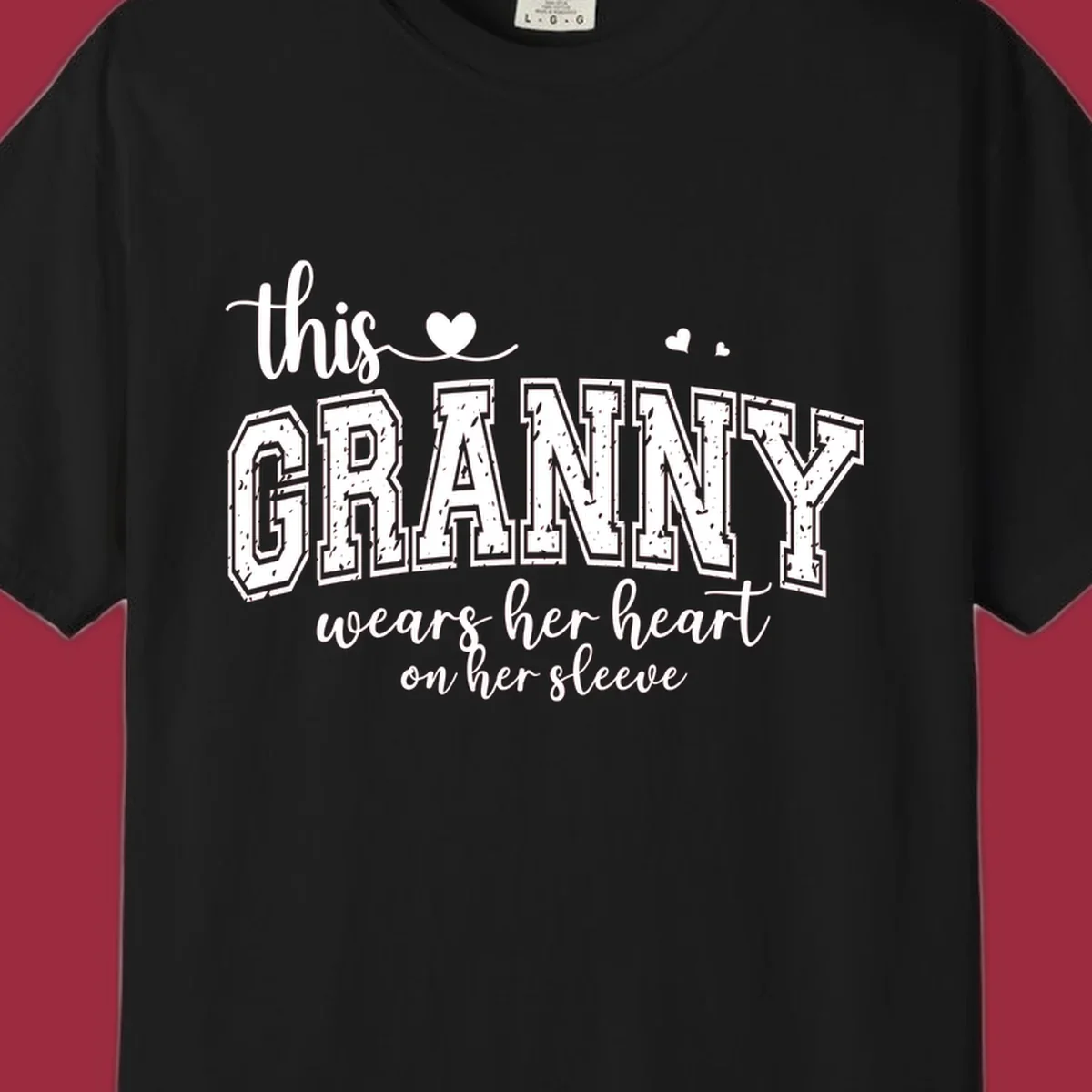 This Granny Wears Her Heart On Her Sleeve text design with heart graphics.