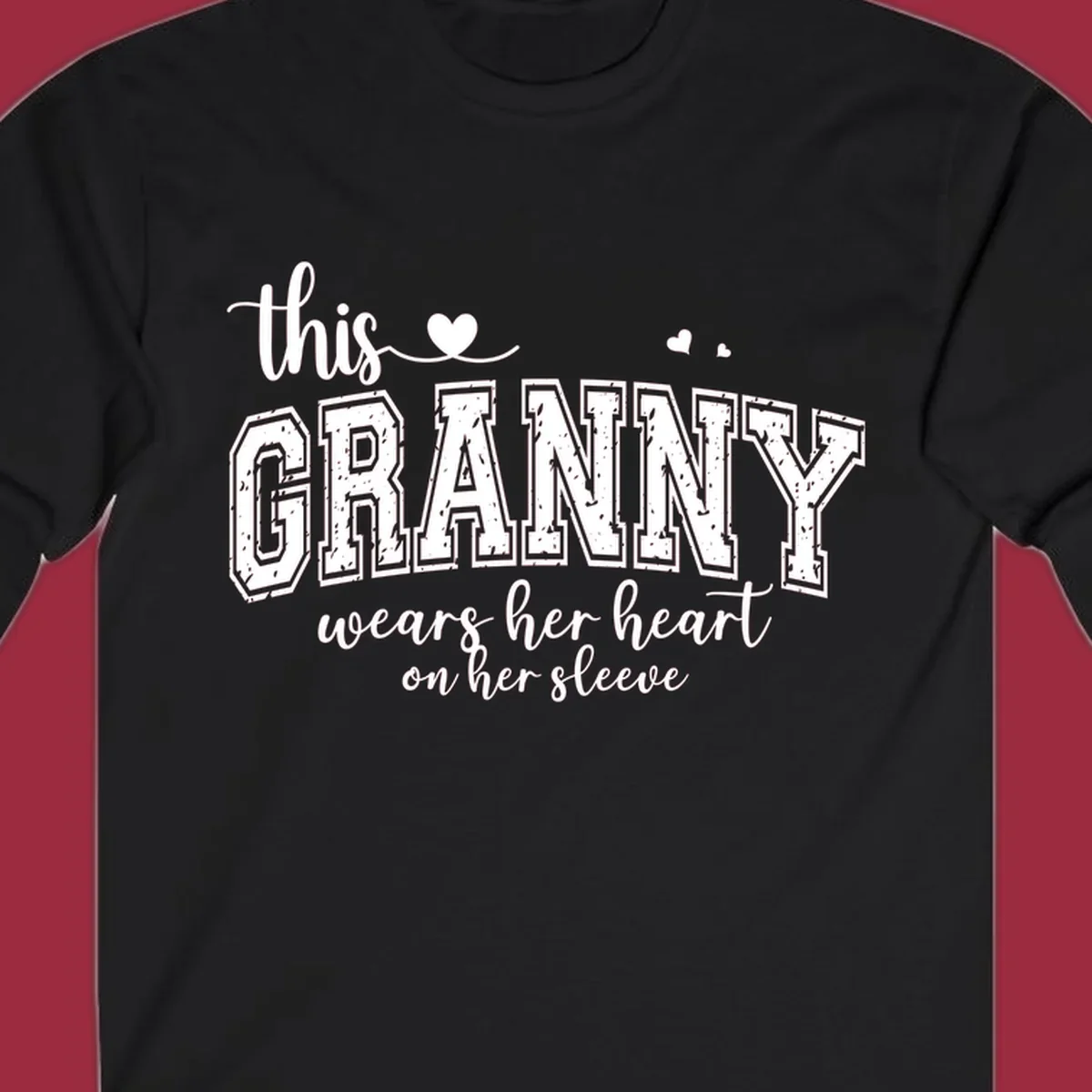 This Granny Wears Her Heart On Her Sleeve text design with heart graphics.