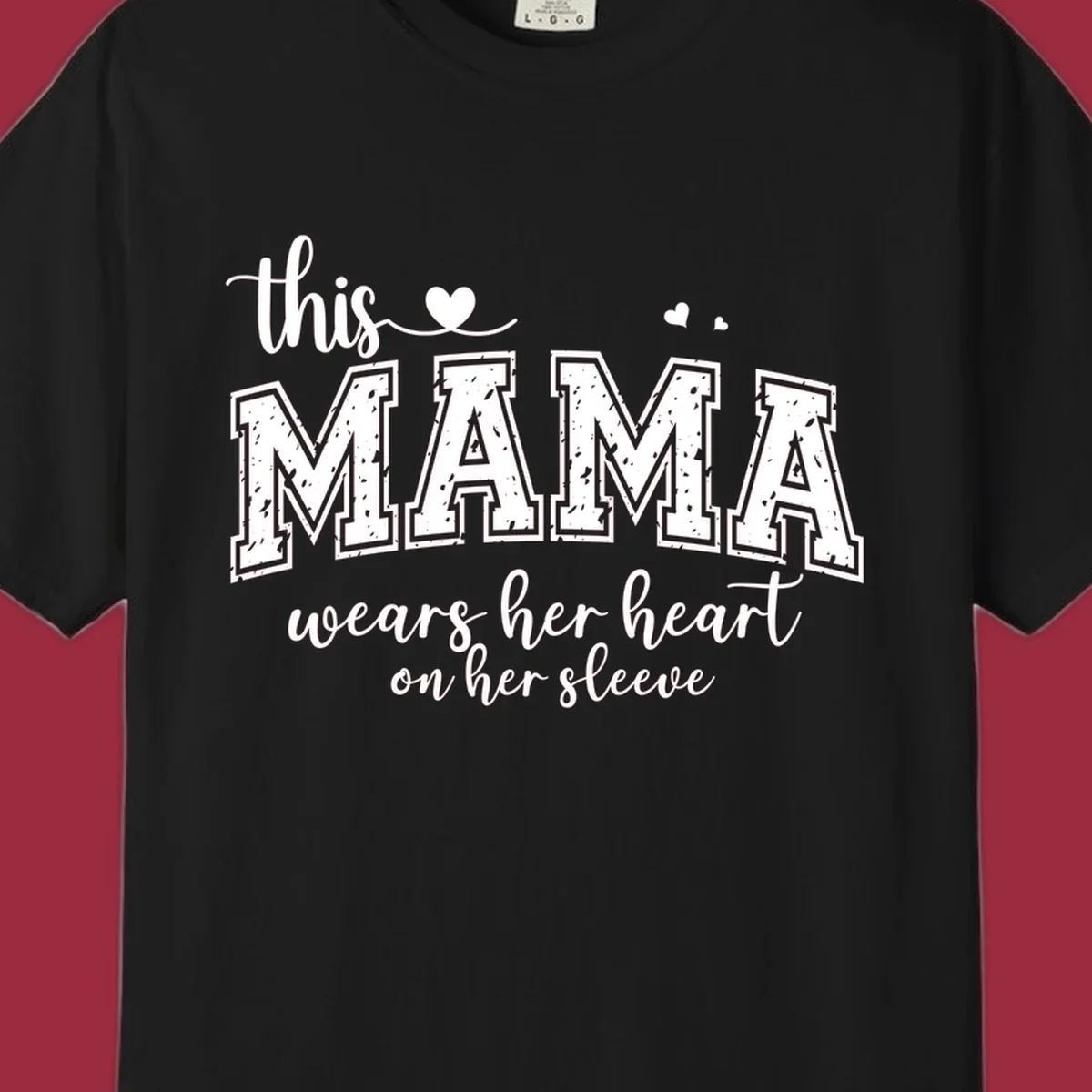 Mama heart on sleeve typography design with script and distressed block text and heart accents.