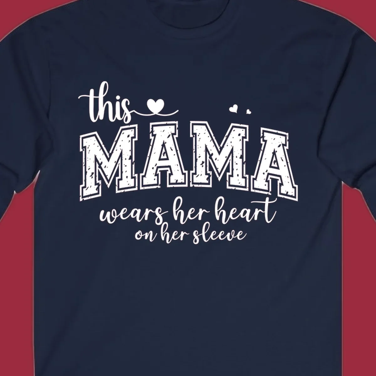 Mama heart on sleeve typography design with script and distressed block text and heart accents.