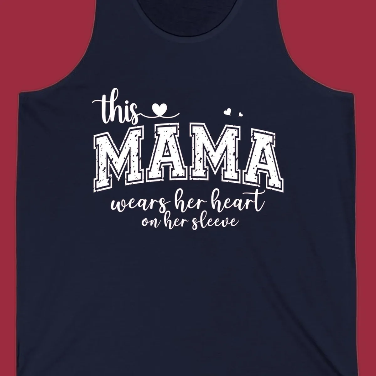 Mama heart on sleeve typography design with script and distressed block text and heart accents.