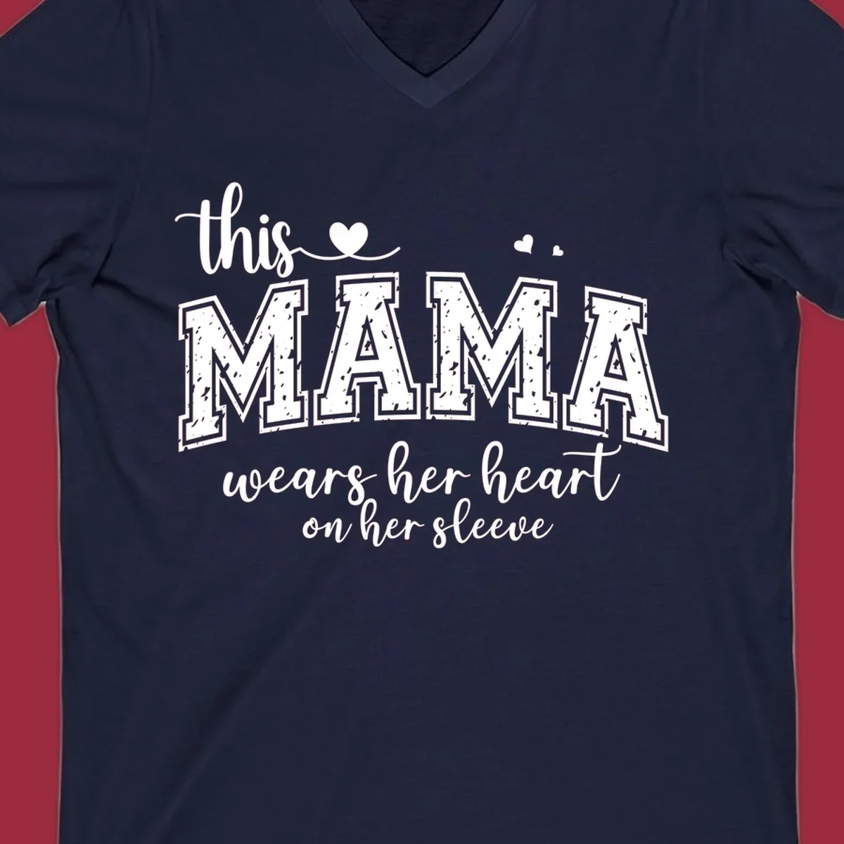 Mama heart on sleeve typography design with script and distressed block text and heart accents.
