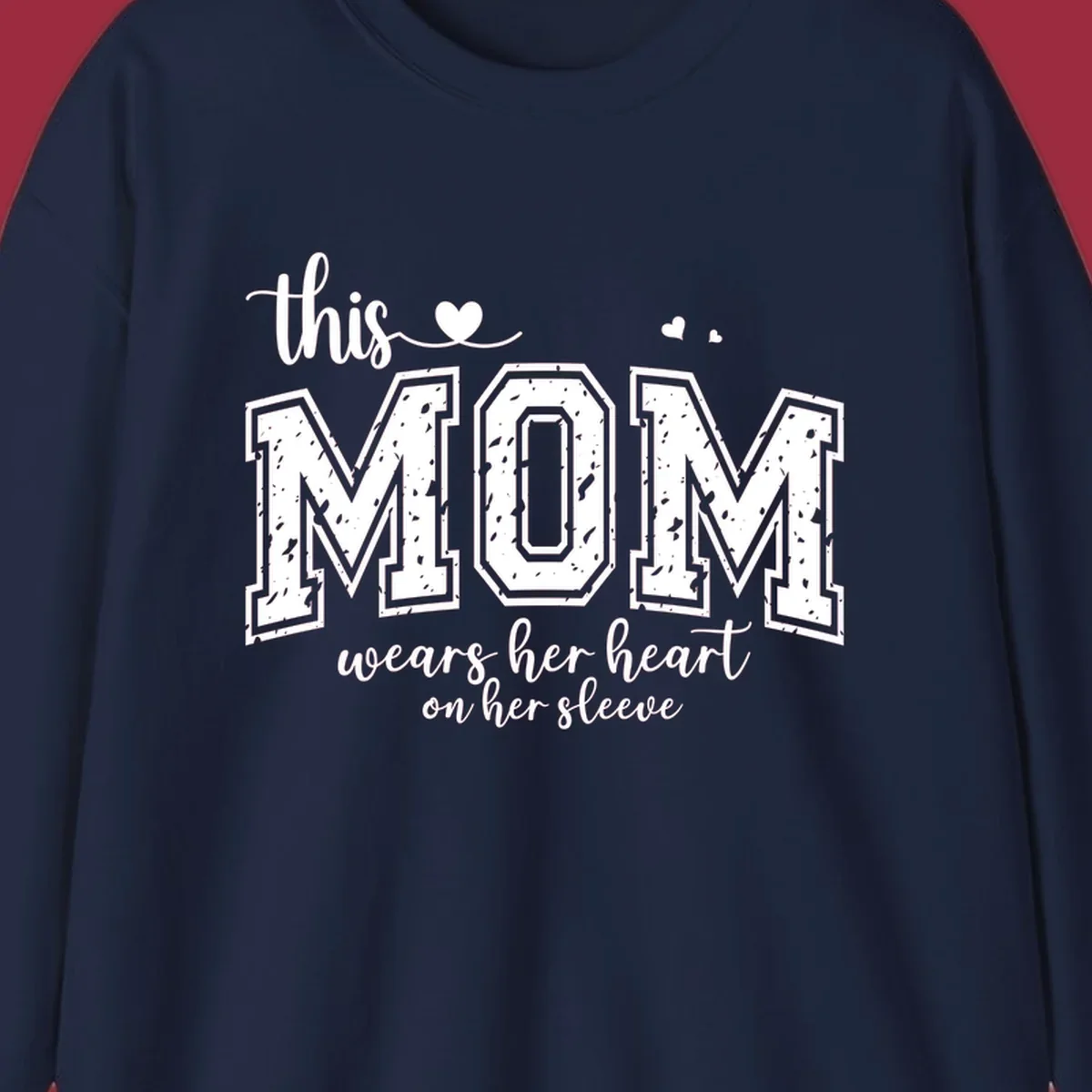 This mom wears her heart on her sleeve graphic with distressed text and heart icons.