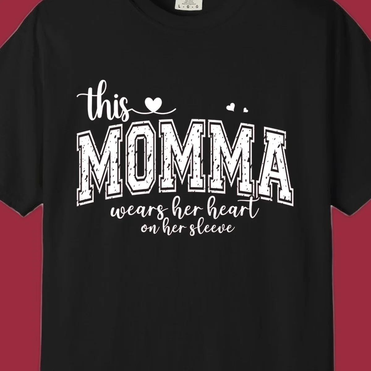 Momma heart on sleeve typography design with script and varsity text and heart icons.