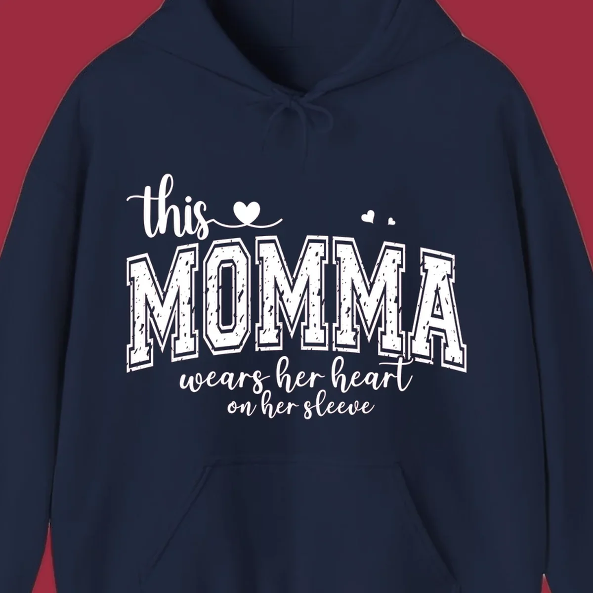 Momma heart on sleeve typography design with script and varsity text and heart icons.
