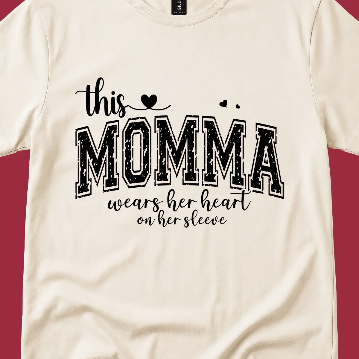 Momma heart on sleeve typography design with script and varsity text and heart icons.
