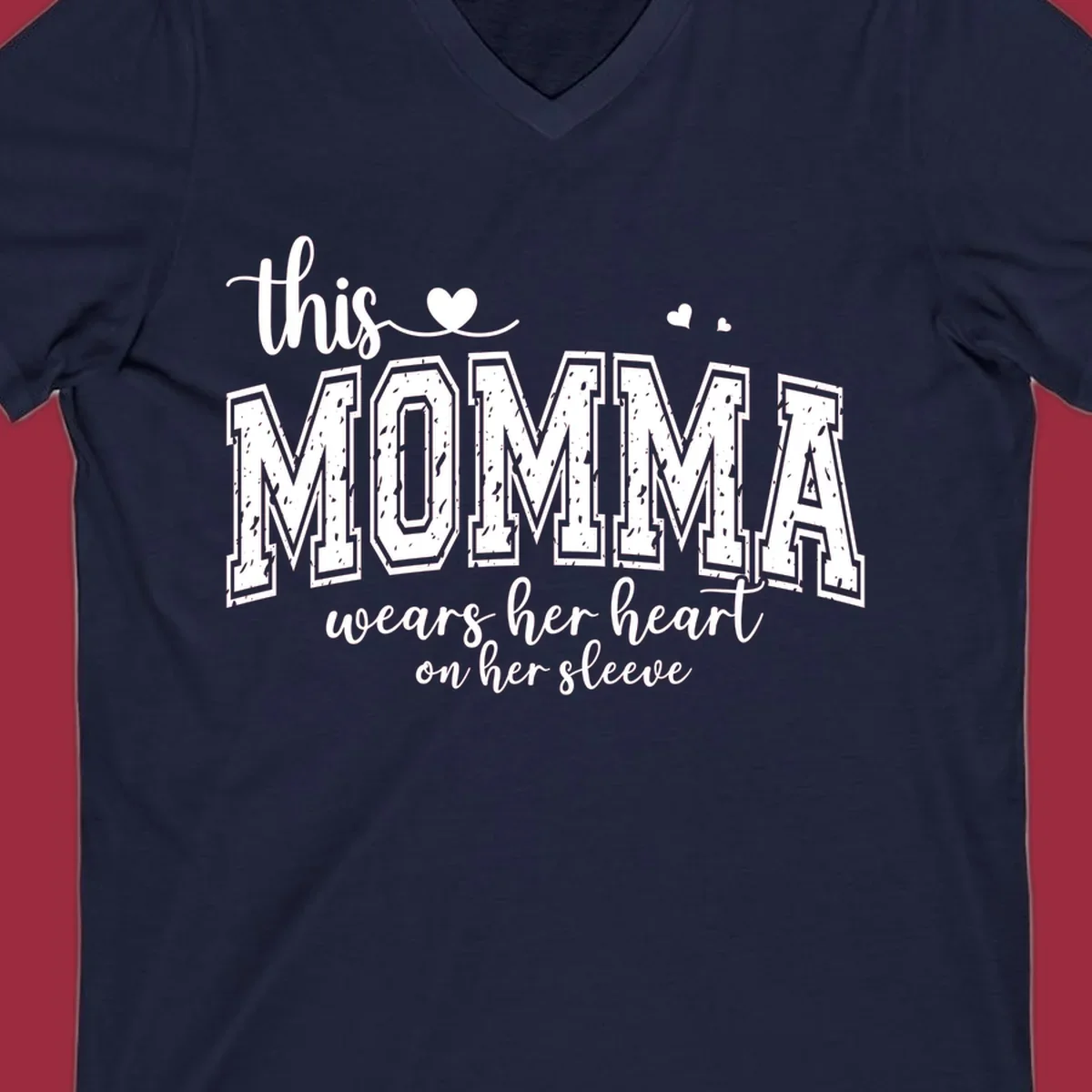 Momma heart on sleeve typography design with script and varsity text and heart icons.