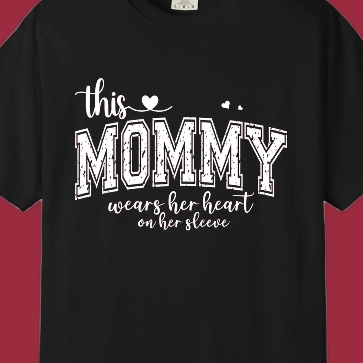 This Mommy Wears Her Heart On Her Sleeve text design with hearts.