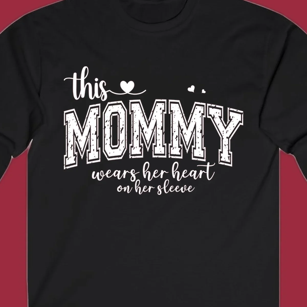 This Mommy Wears Her Heart On Her Sleeve text design with hearts.