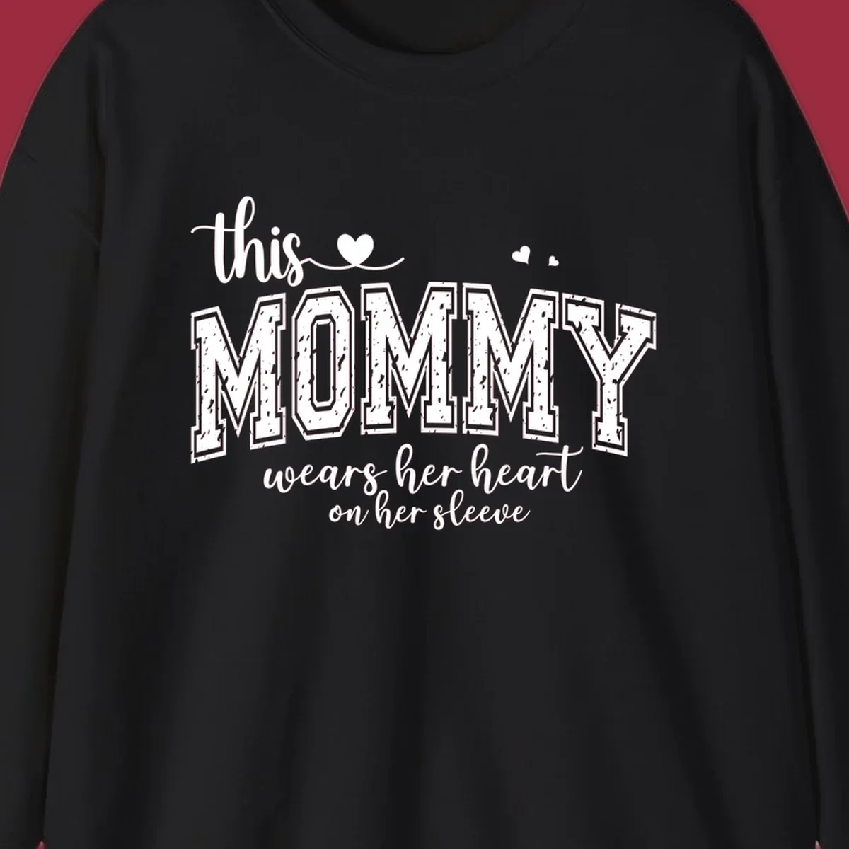 This Mommy Wears Her Heart On Her Sleeve text design with hearts.