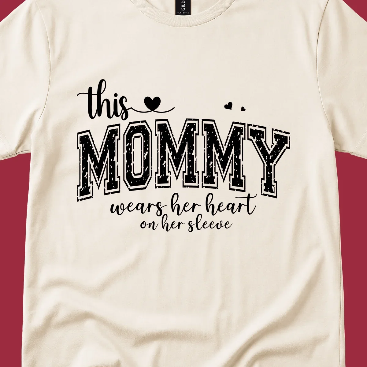 This Mommy Wears Her Heart On Her Sleeve text design with hearts.