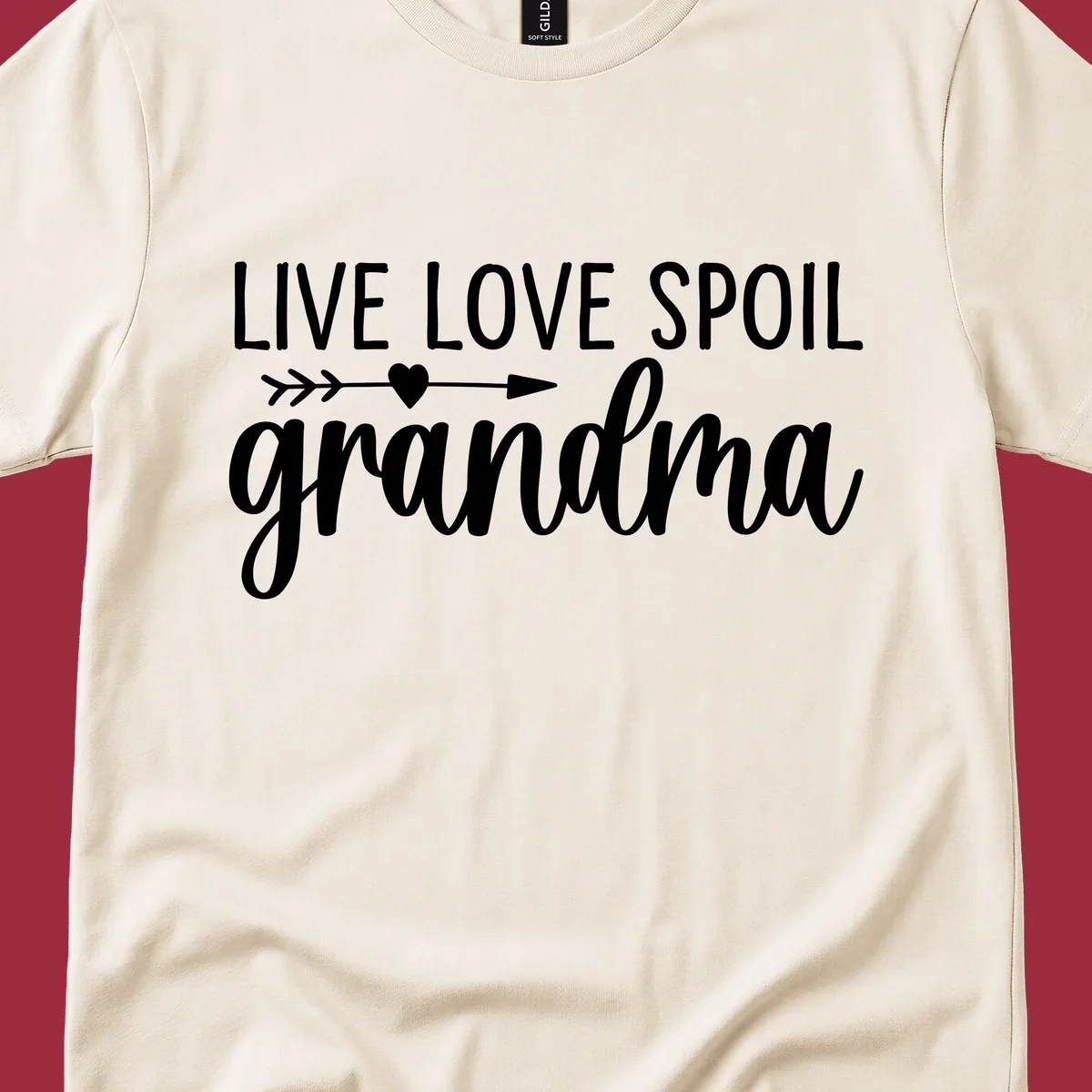 Live Love Spoil Grandma typography design with heart and arrow.