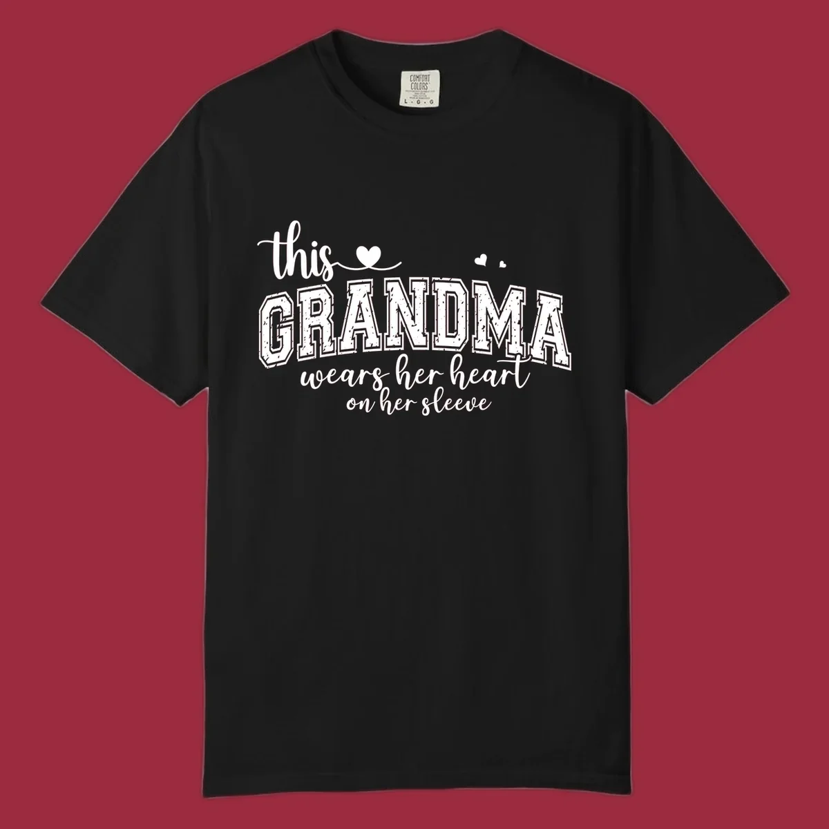 This Grandma Wears Her Heart On Her Sleeve text design with hearts.