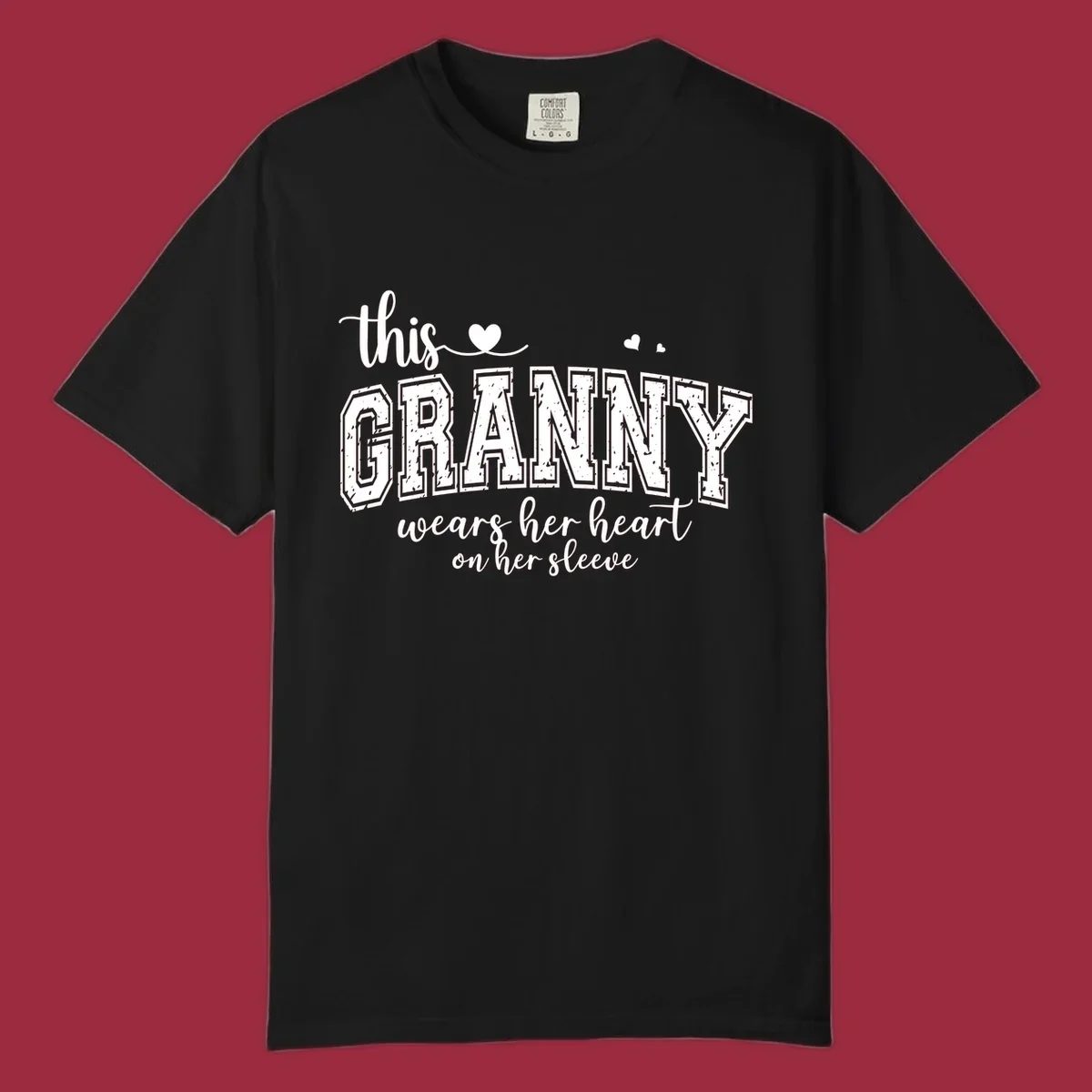 This Granny Wears Her Heart On Her Sleeve text design with heart graphics.