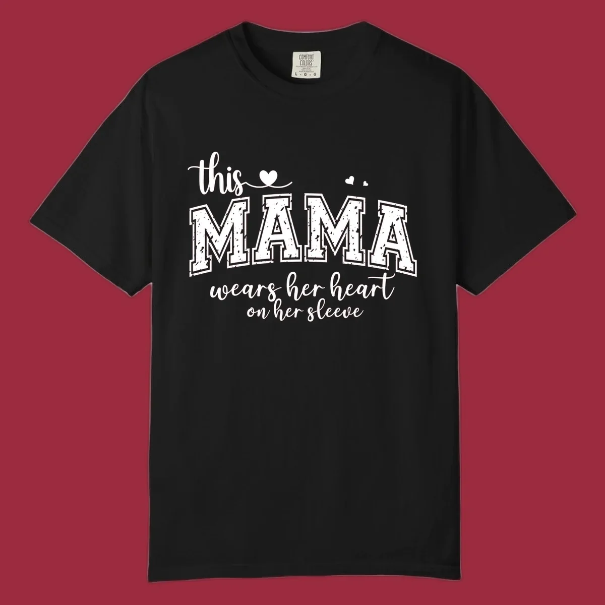 Mama heart on sleeve typography design with script and distressed block text and heart accents.