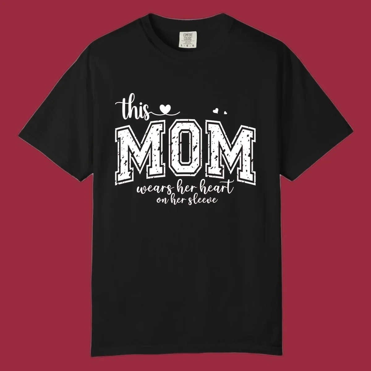 This mom wears her heart on her sleeve graphic with distressed text and heart icons.