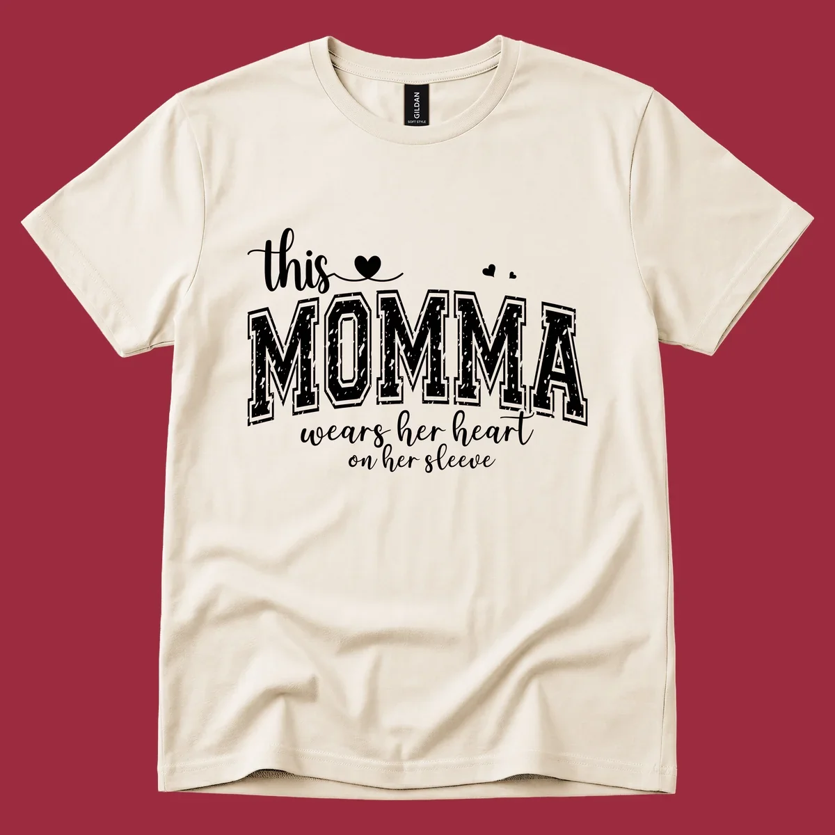 Momma heart on sleeve typography design with script and varsity text and heart icons.