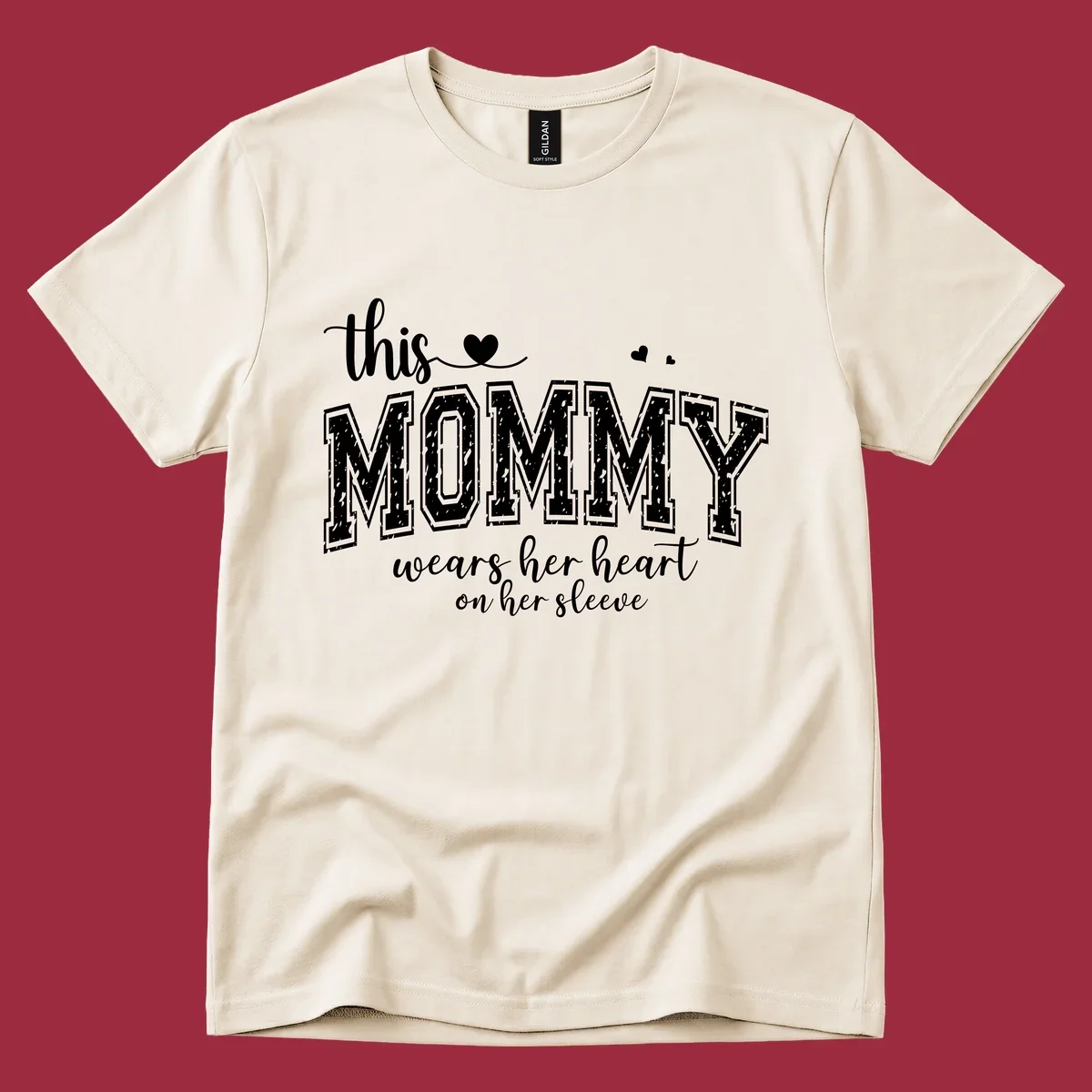 This Mommy Wears Her Heart On Her Sleeve text design with hearts.