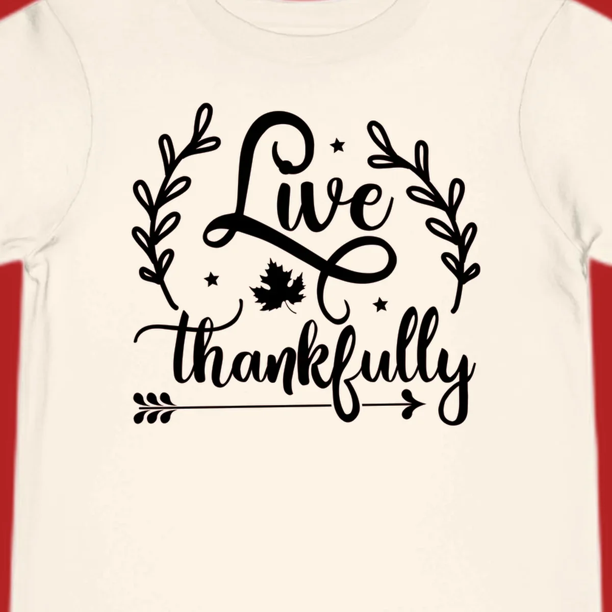 Live thankfully fall design with script text, leaves, and stars.